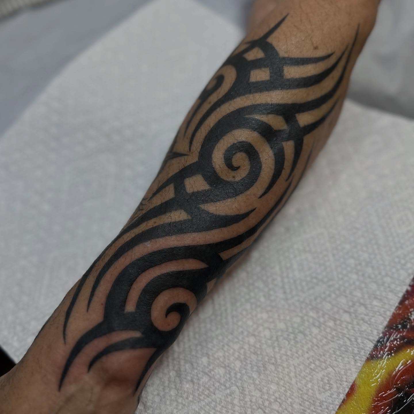 Tribal swirl tribal tattoo on the forearm by Alexa Wolfkiel