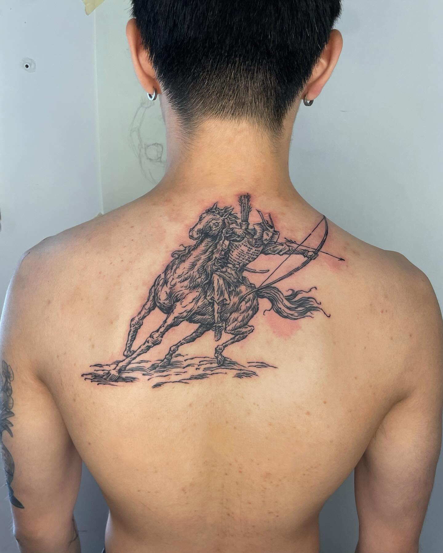 Horse rider black and grey tattoo on the back by Anh Đan