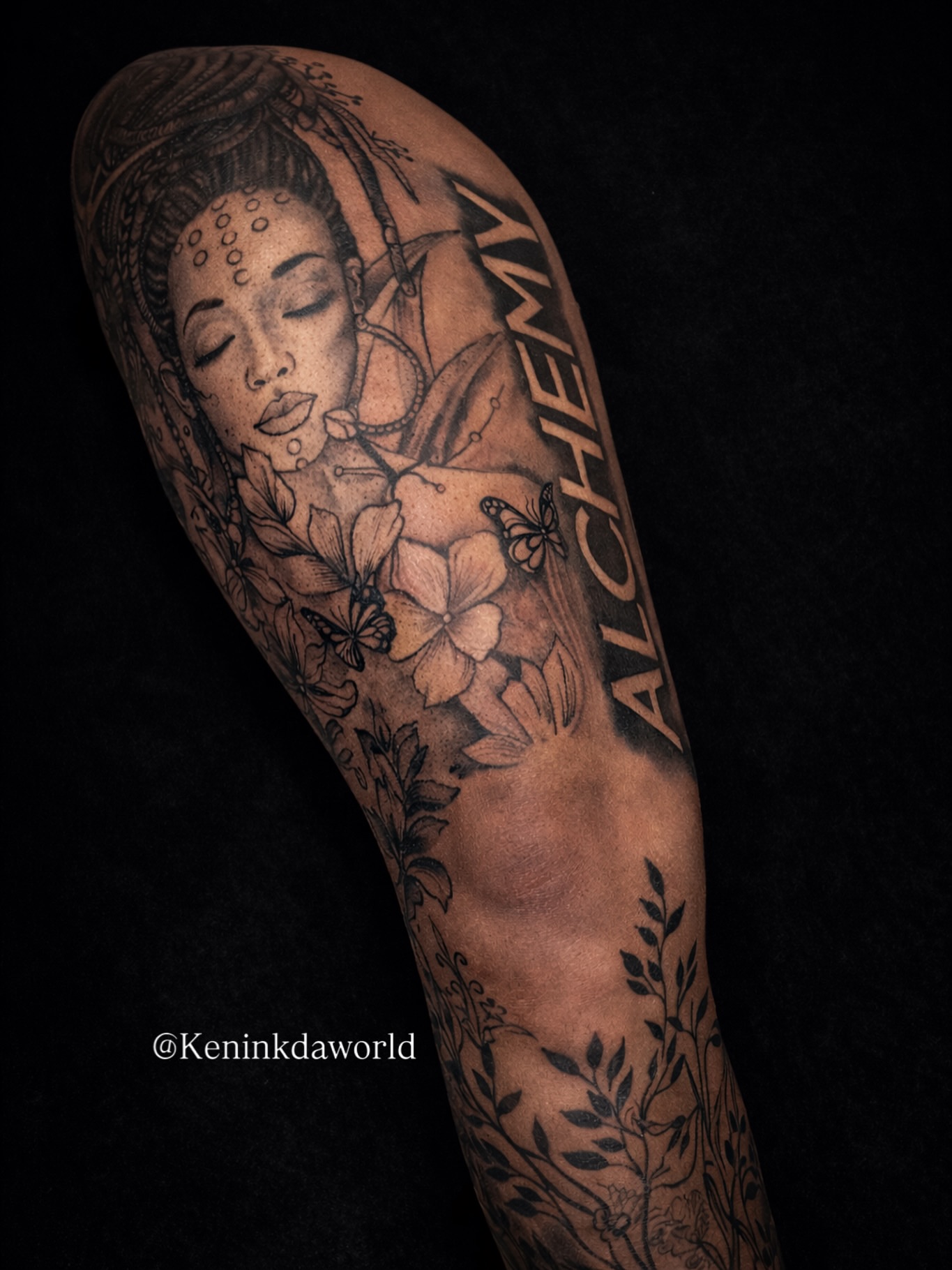 Woman with flowers realism tattoo on the forearm by Ken West