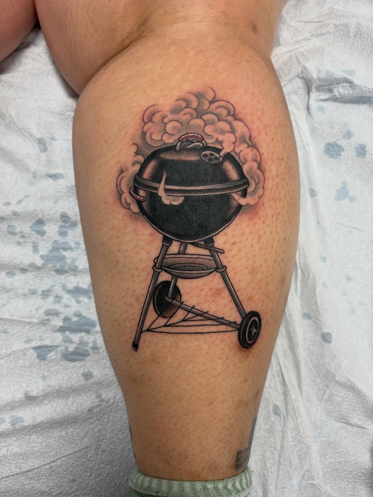 Barbecue grill black and grey tattoo on the thigh by Jakob Ristau, Kansas City, Missouri