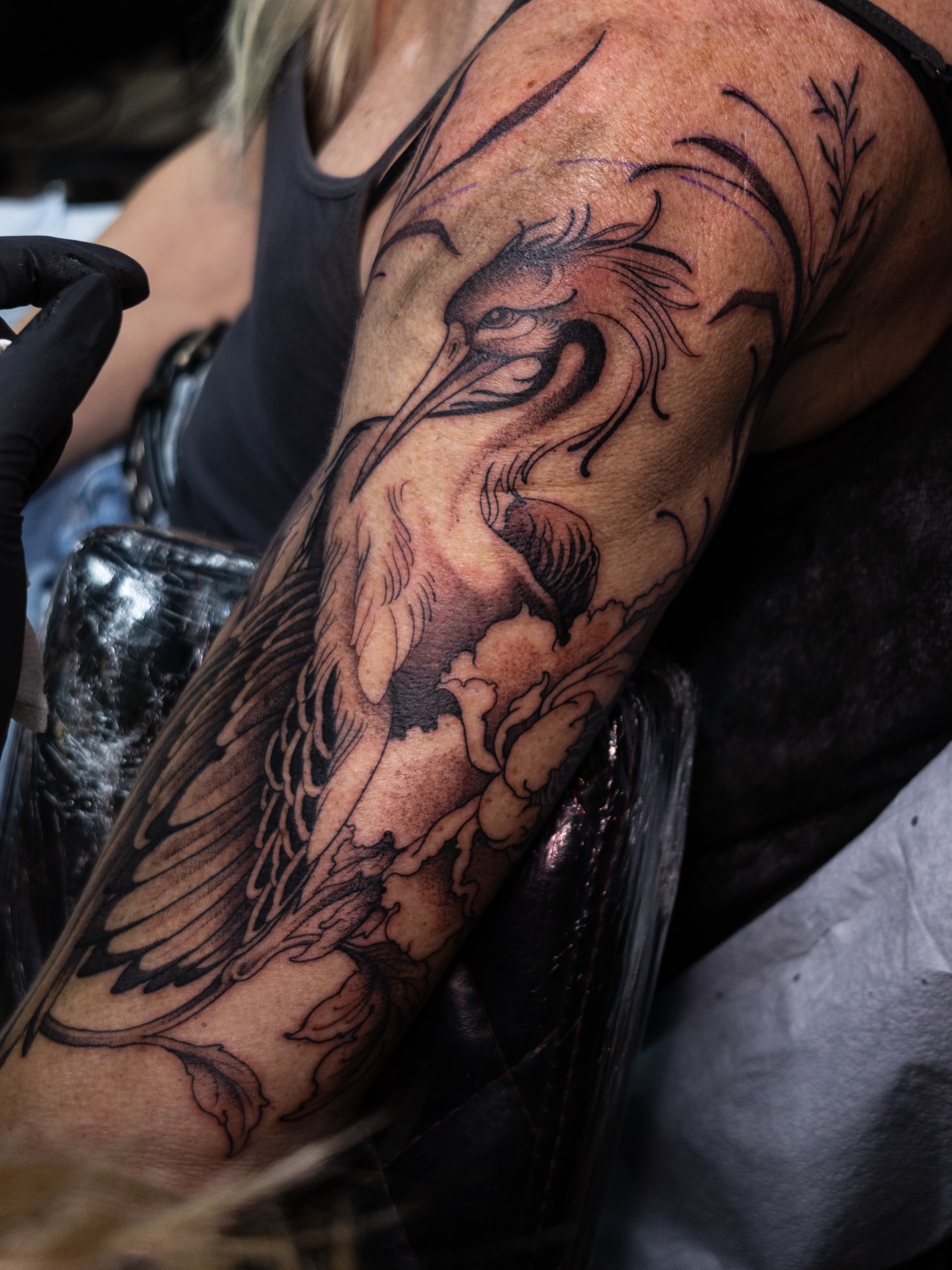 Phoenix black and grey tattoo on the forearm by Carrie