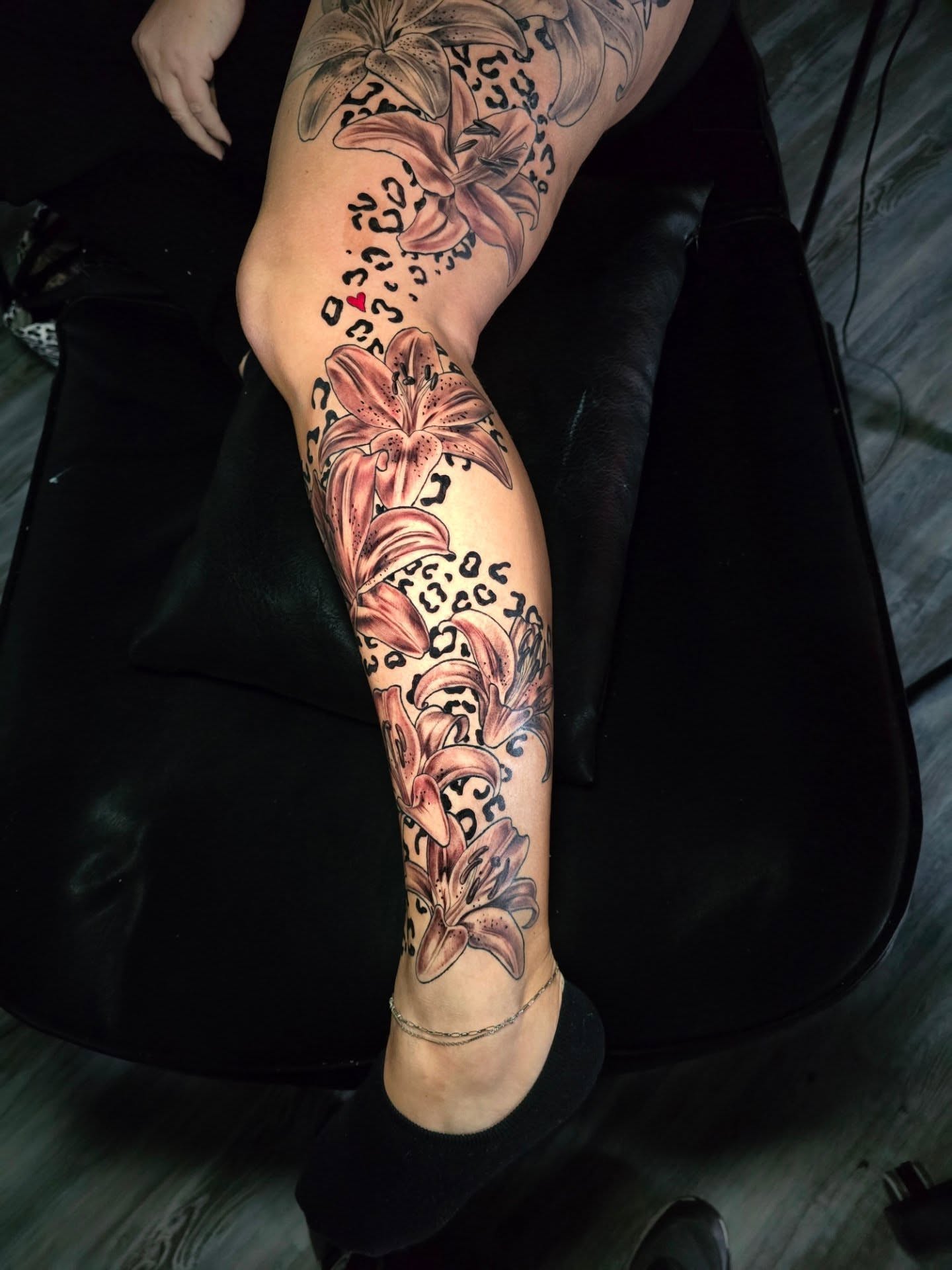 Lily flowers American traditional tattoo on the leg by Camuel Whaley