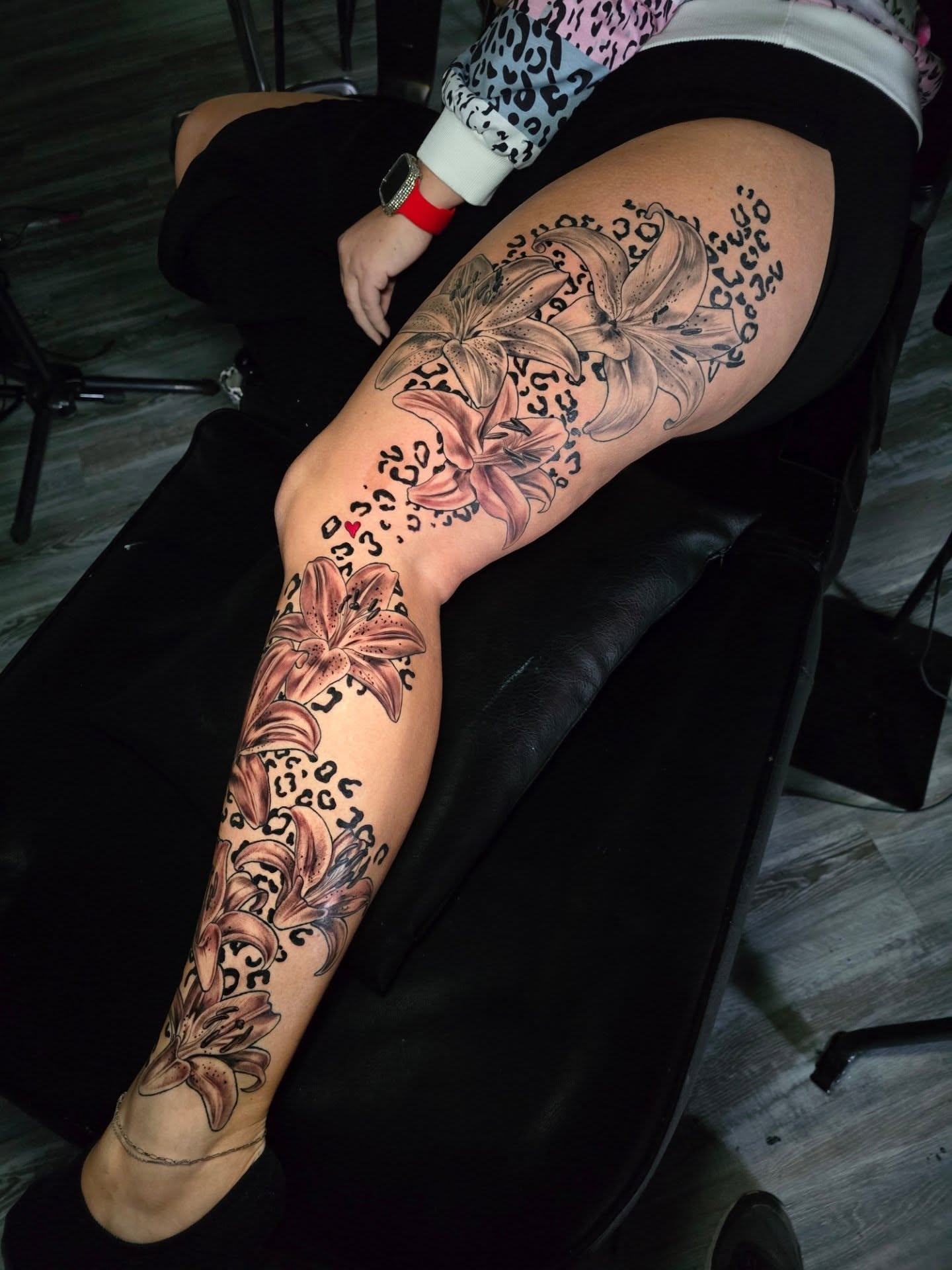 Lilies black and grey tattoo on the thigh by Camuel Whaley