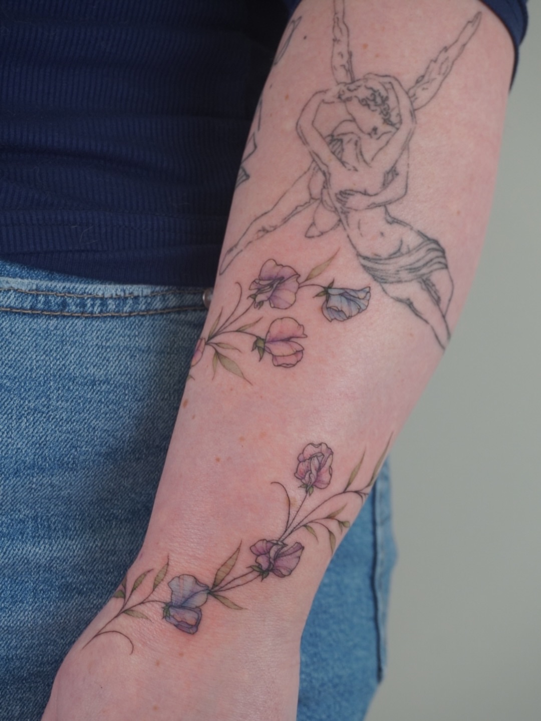 Flowers and angel watercolor tattoo on the forearm by Sun Child Tattoo 🌻