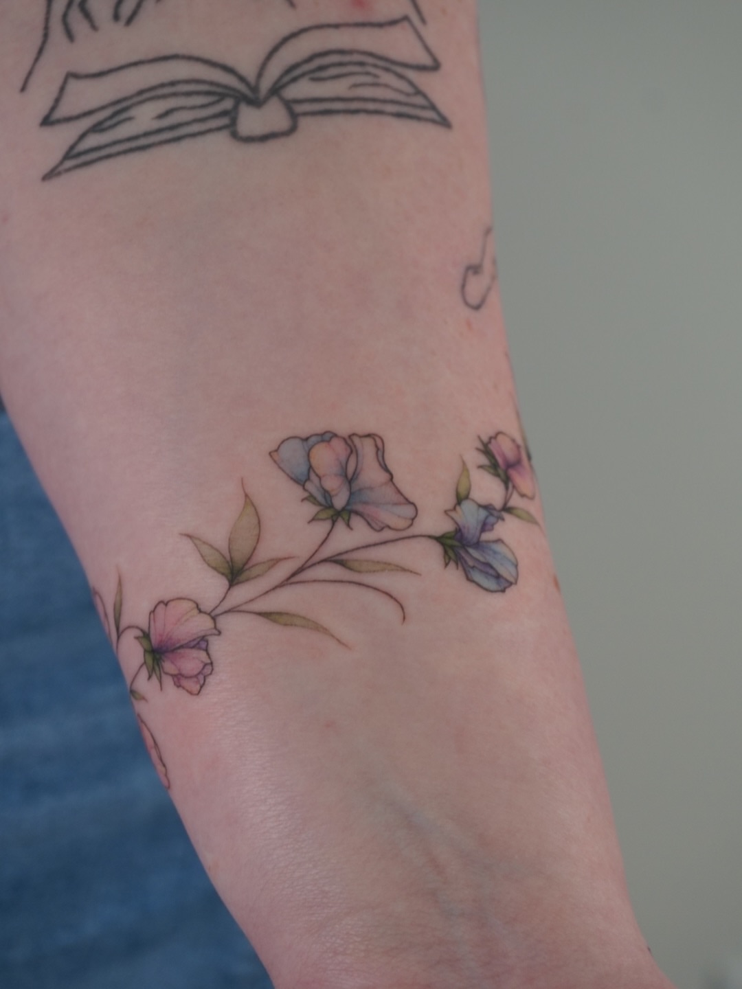 Flowers watercolor tattoo on the forearm by Sun Child Tattoo 🌻