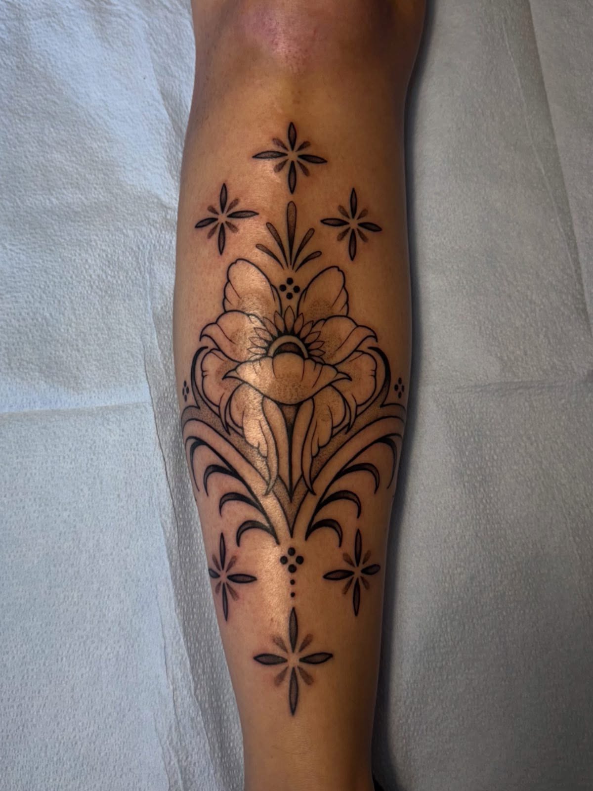 Floral design ornamental tattoo on the forearm by Erin Shea