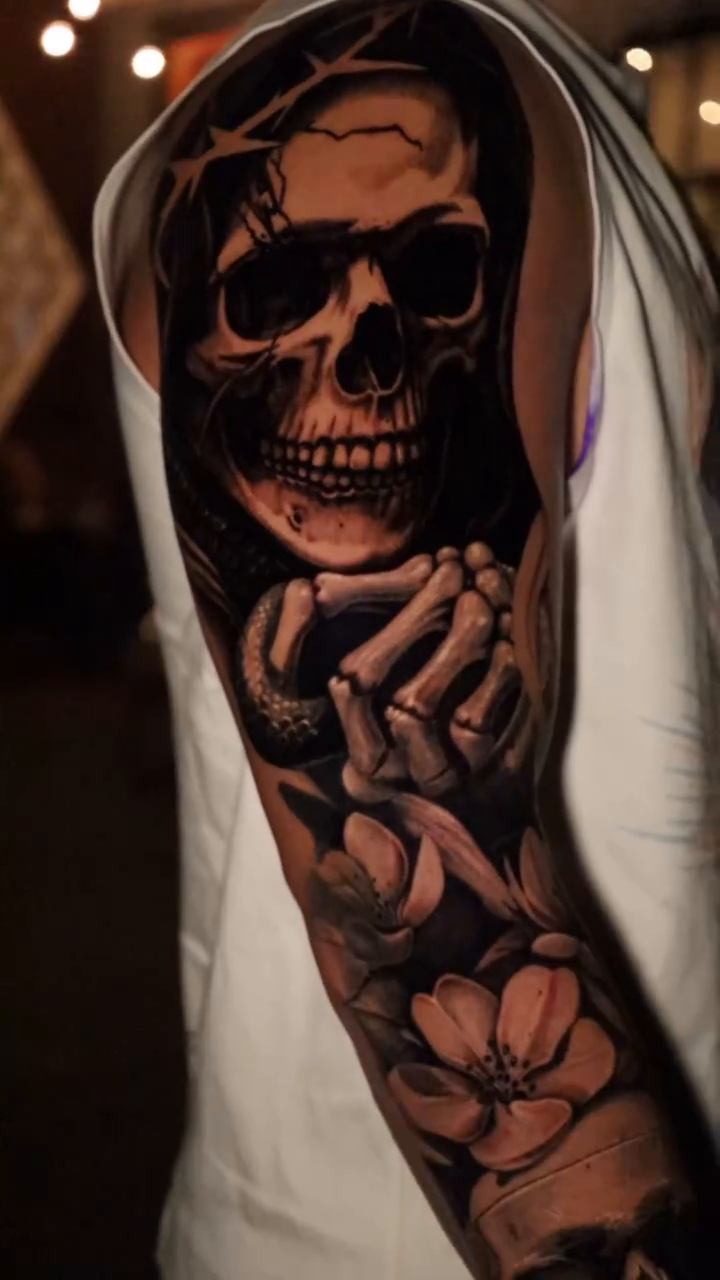 Skull with flowers realism tattoo by Bryan Palacios