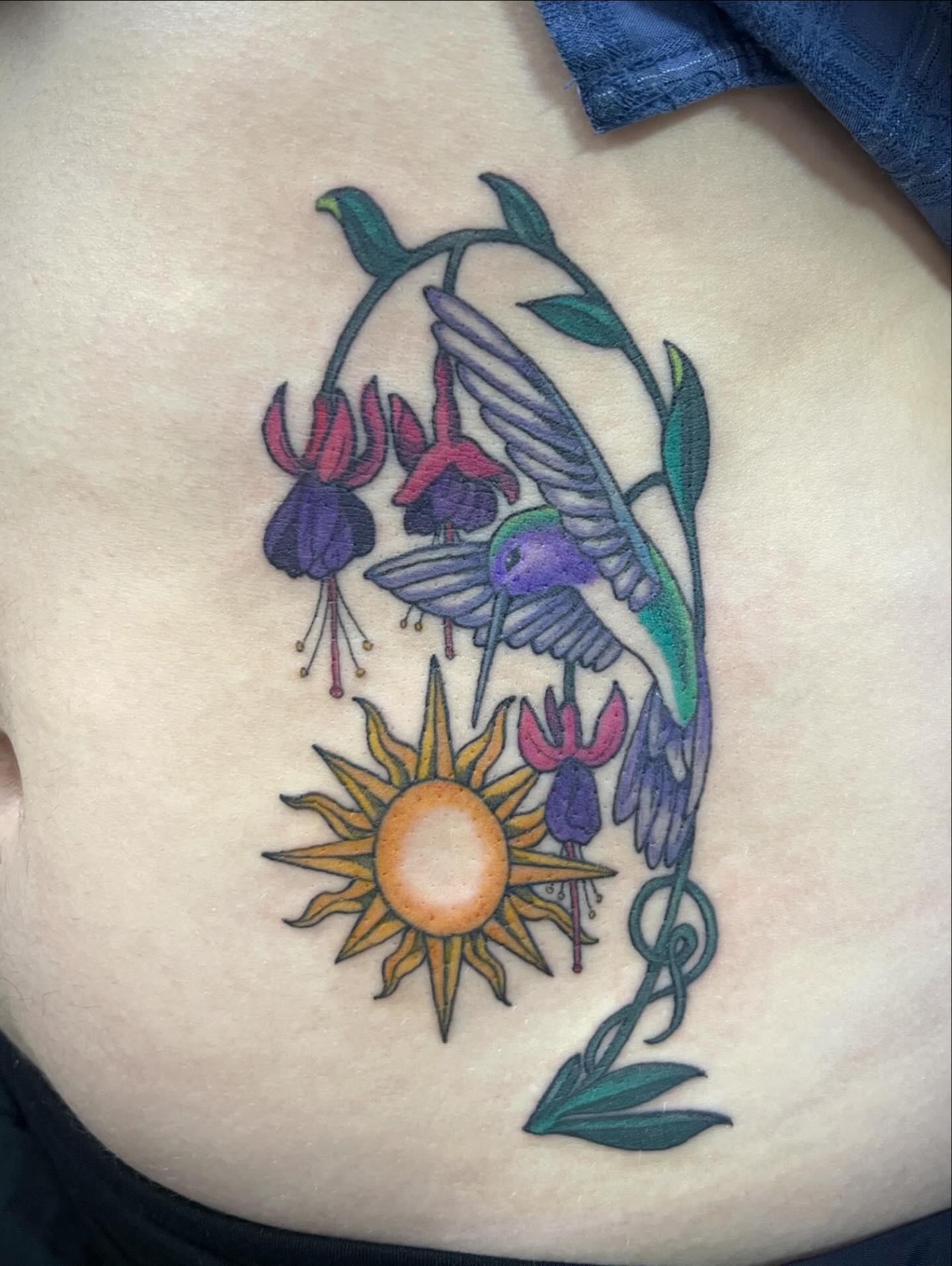 Hummingbird and fuchsia new school tattoo on the ribs by Natalie Phillips, Oakland, California