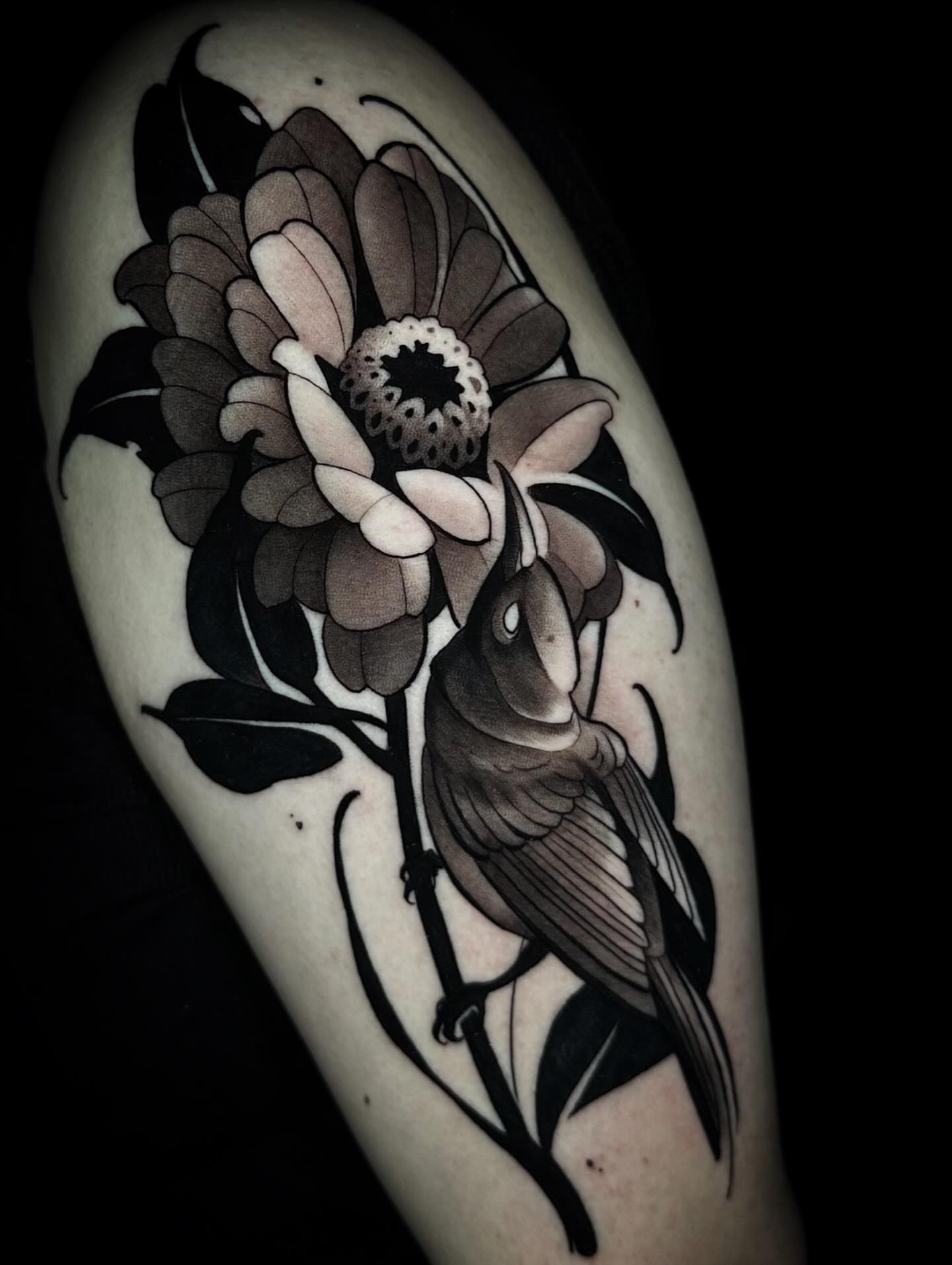 Flower and bird black and grey tattoo on the forearm by Nathan Adsit
