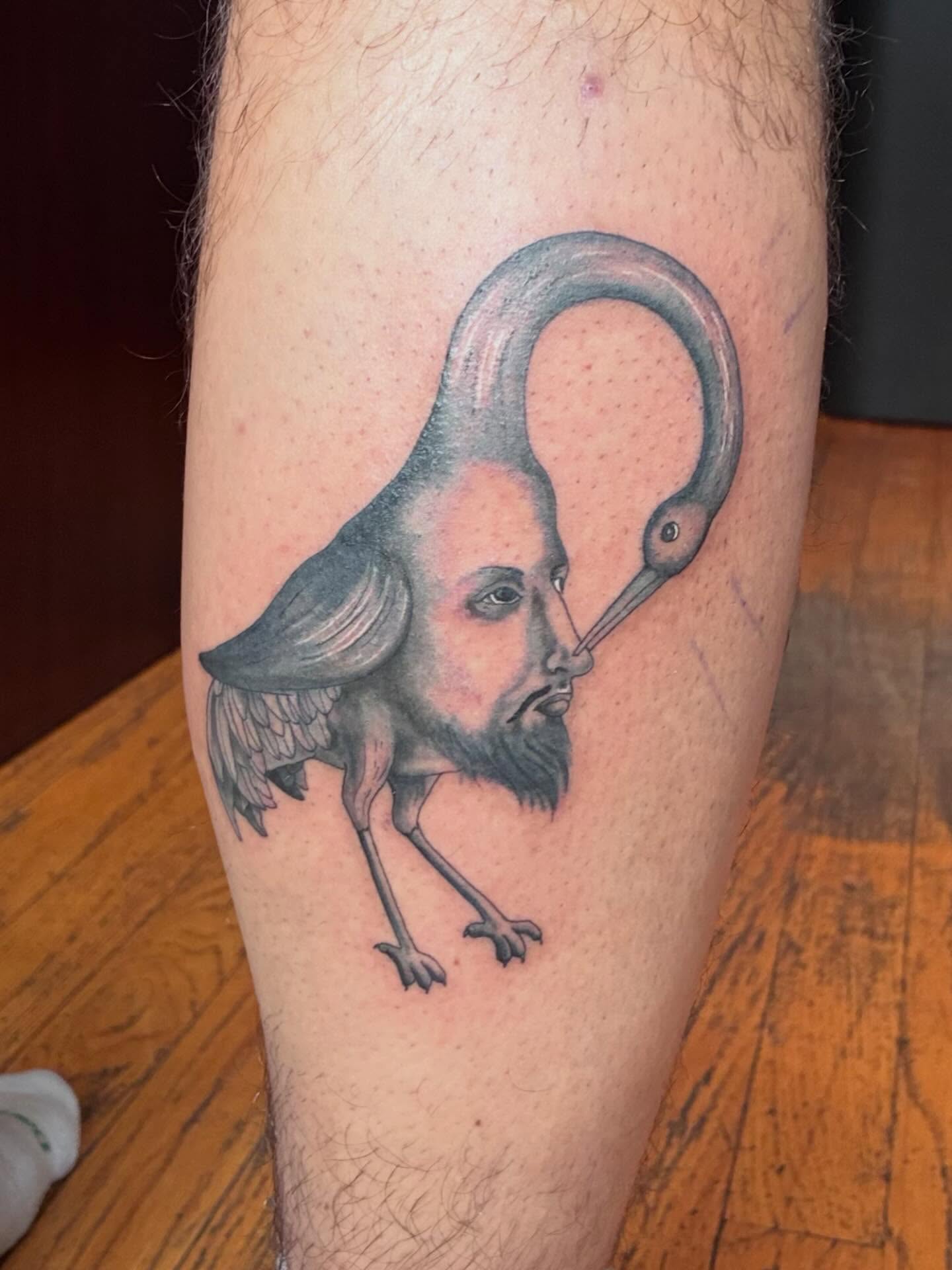 Man with bird head realism tattoo on the leg by Linzi Hungerford, Bozeman, Montana