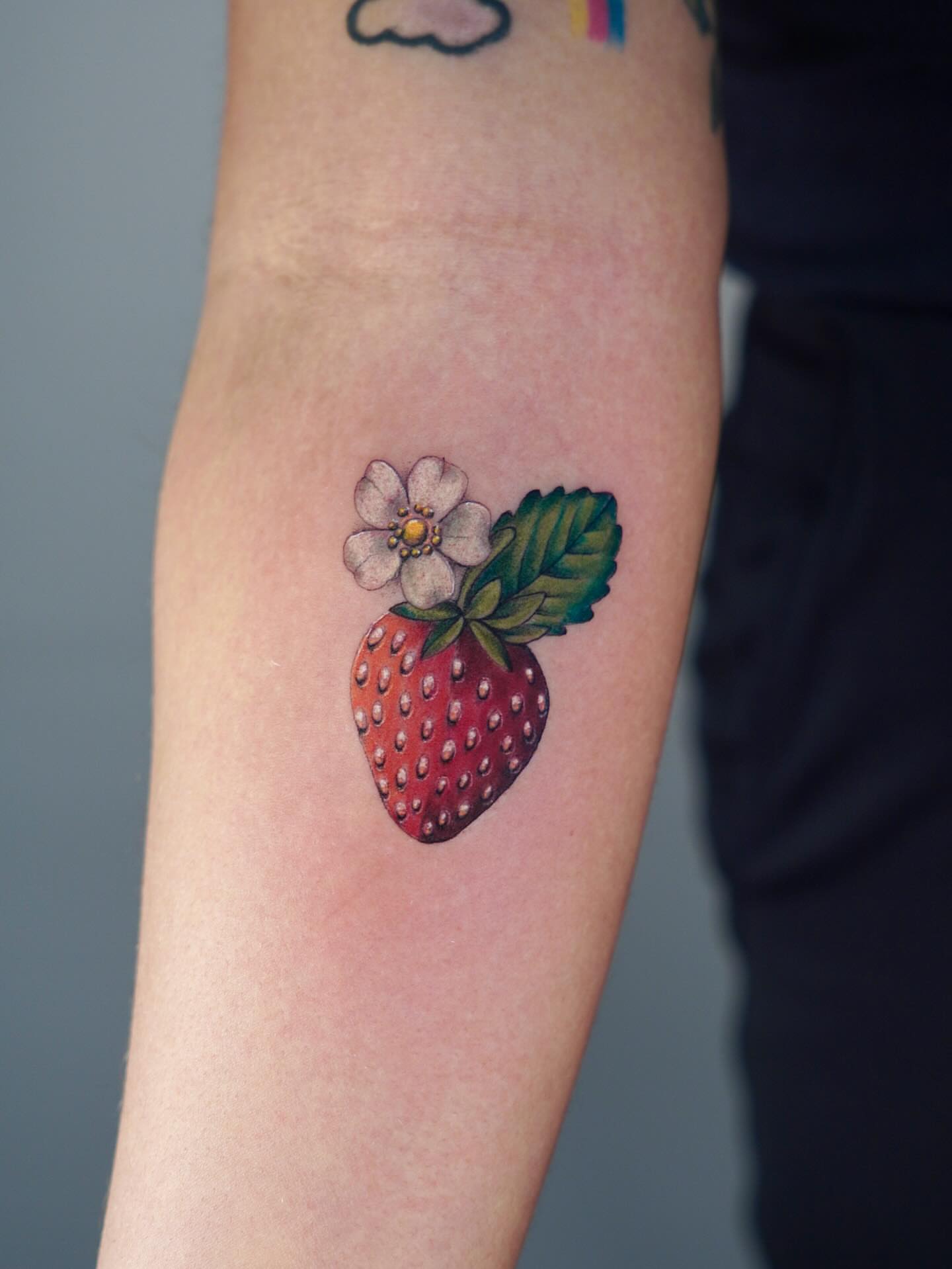 Strawberry realism tattoo on the forearm by Marianna D D King