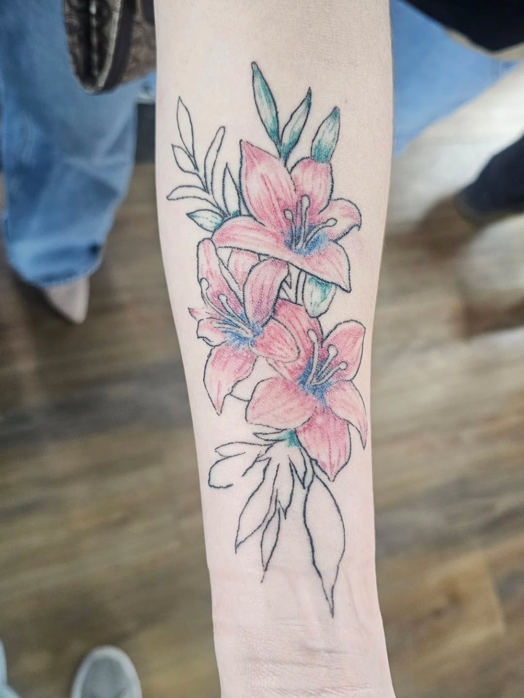 Pink lilies fine line tattoo on the forearm by John Briceño, Columbus, Ohio