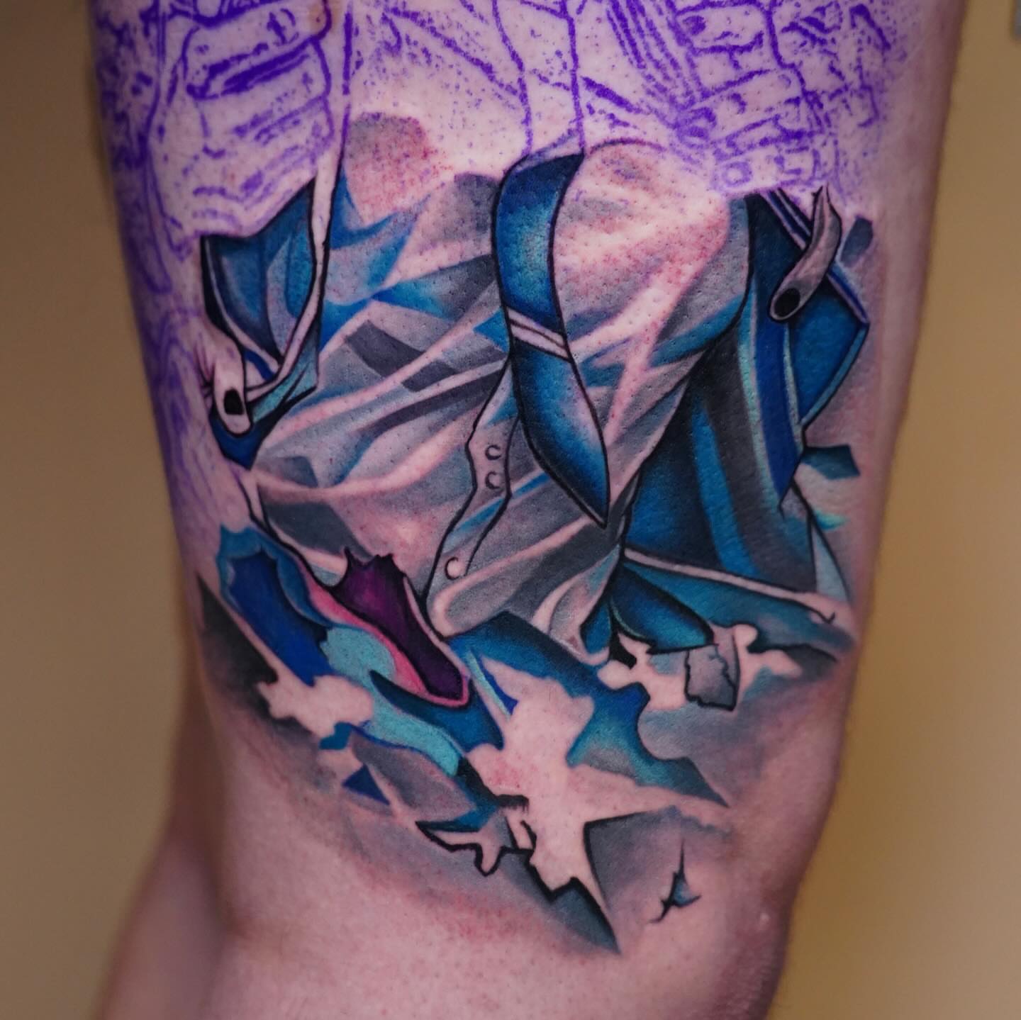 Abstract blue and purple design geometric tattoo on the forearm by Navei