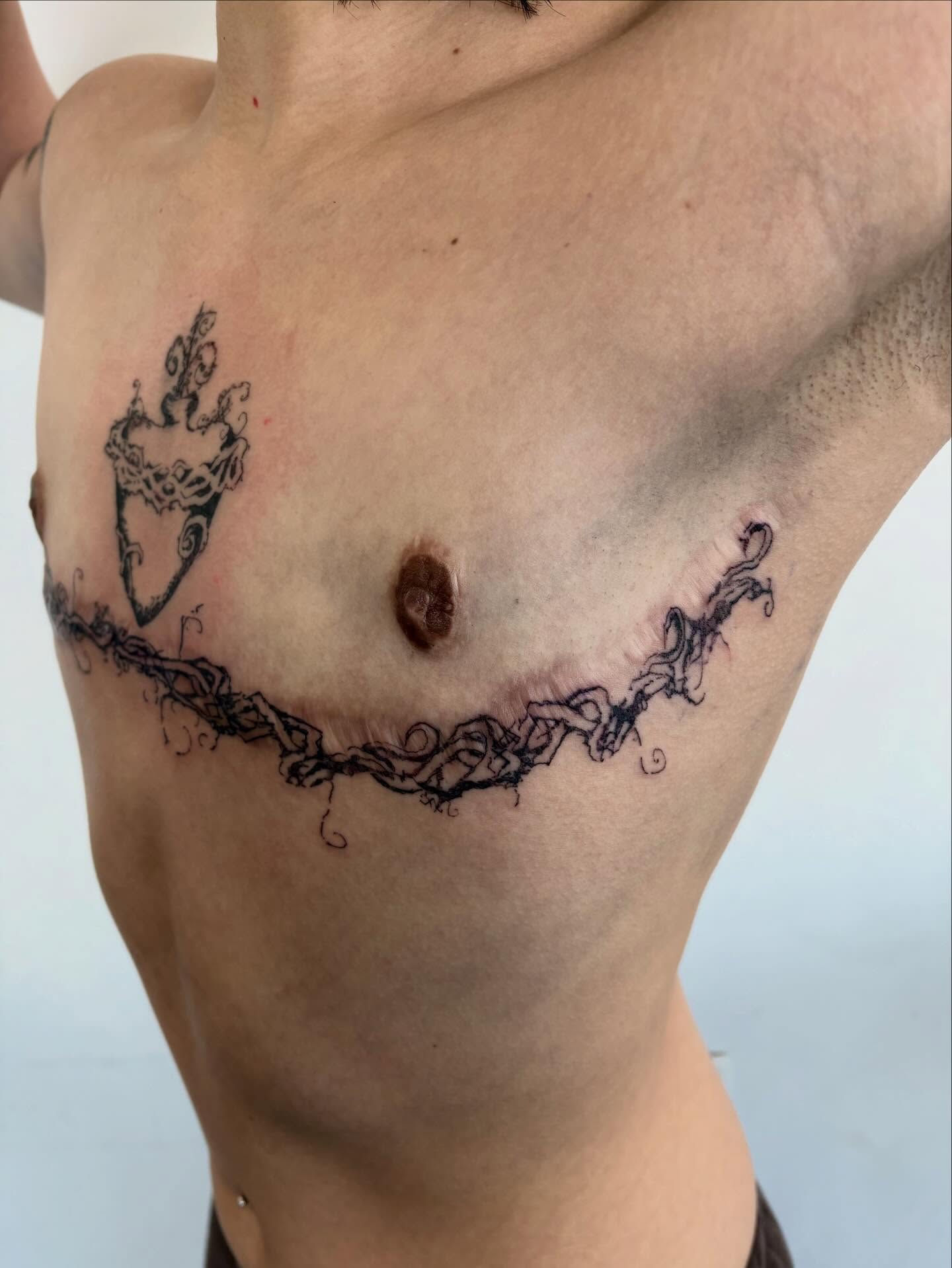 Anchor and vine black and grey tattoo on the chest by madeline