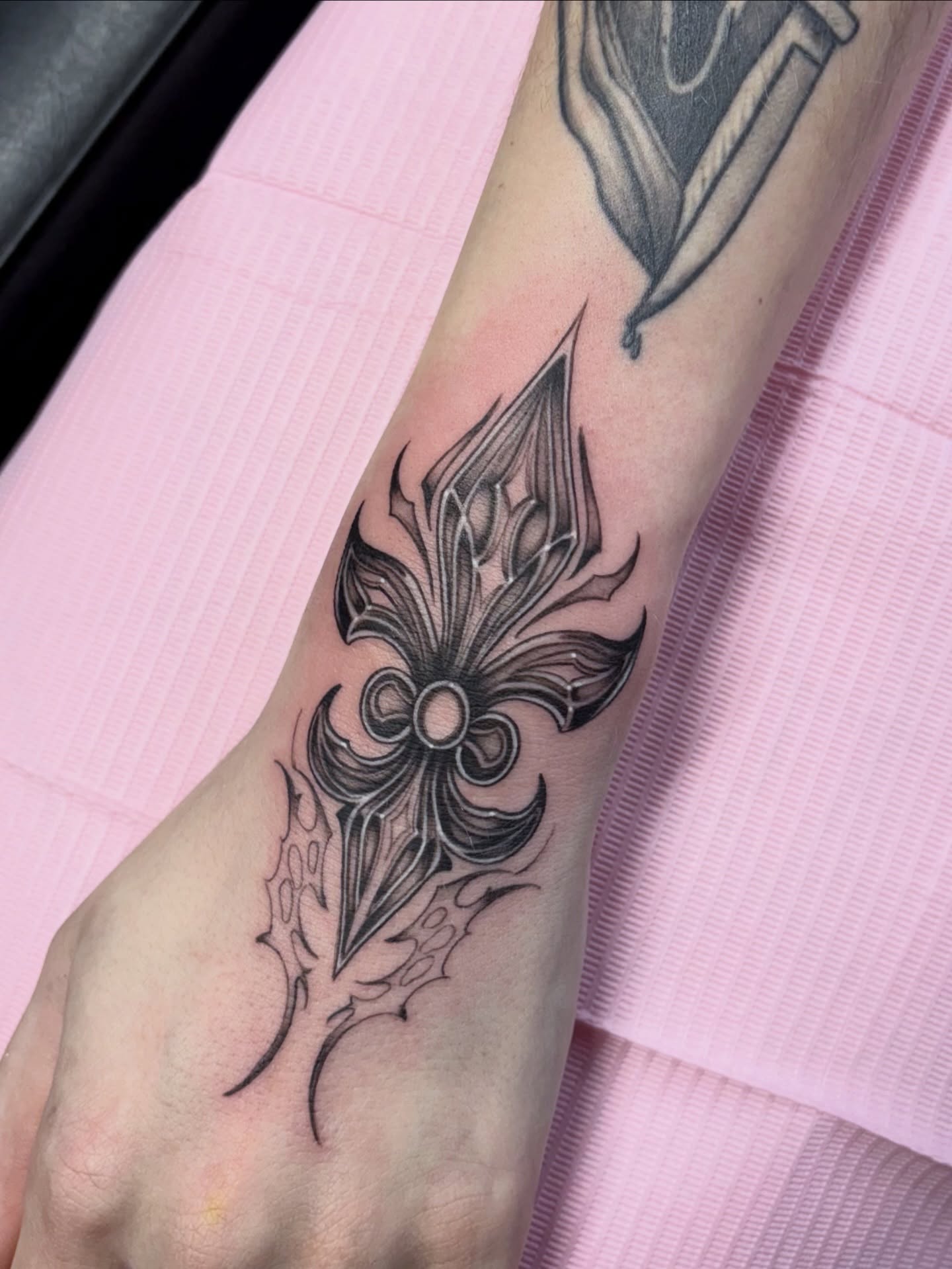 Fleur-de-lis black and grey tattoo on the forearm by Elixabeth