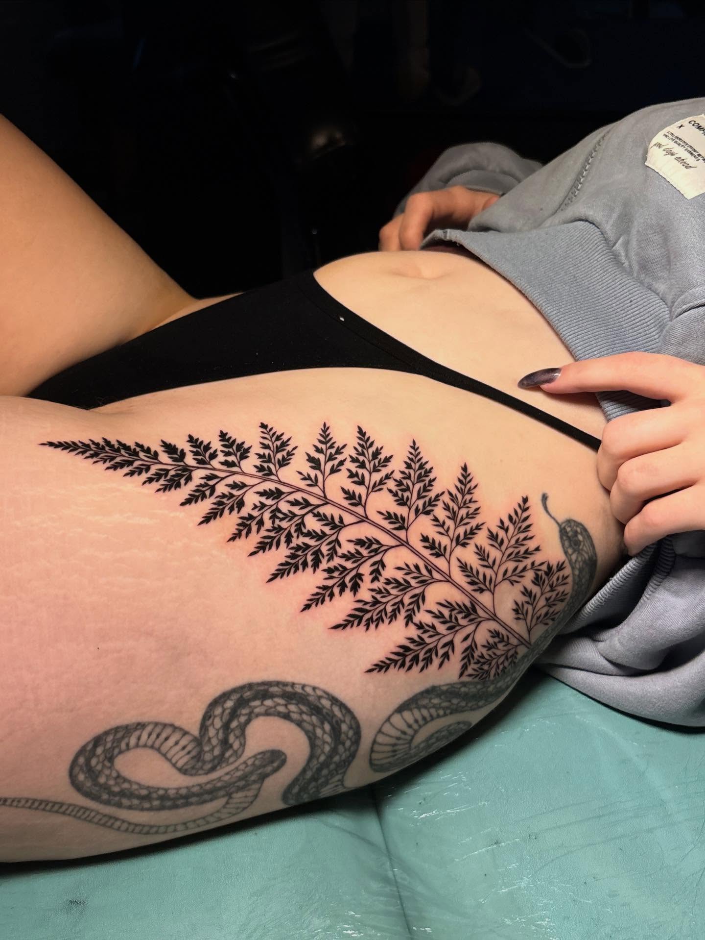 Fern black and grey tattoo on the thigh by Nikko