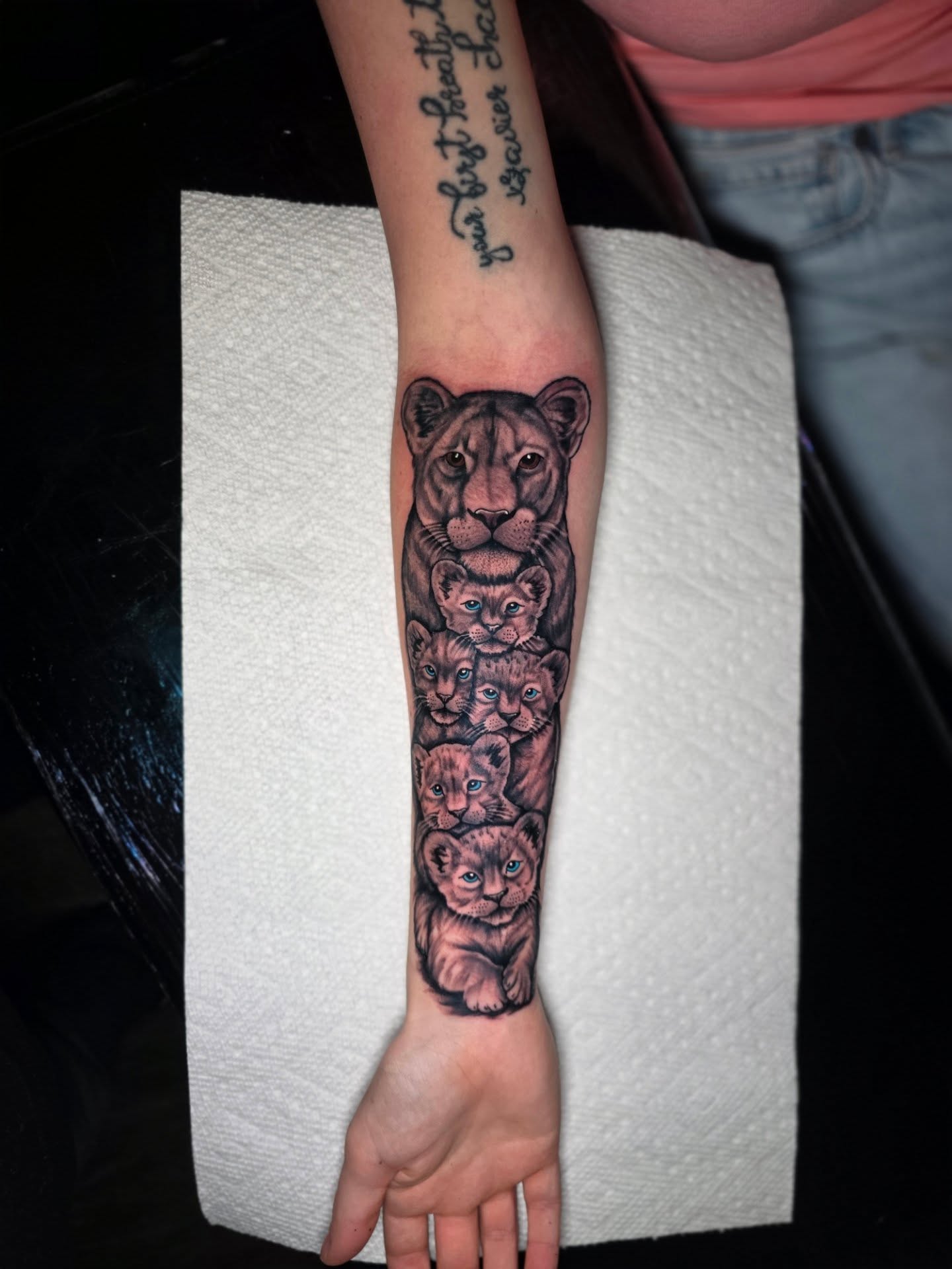 Lion cubs realism tattoo on the forearm by Dylan Fowler