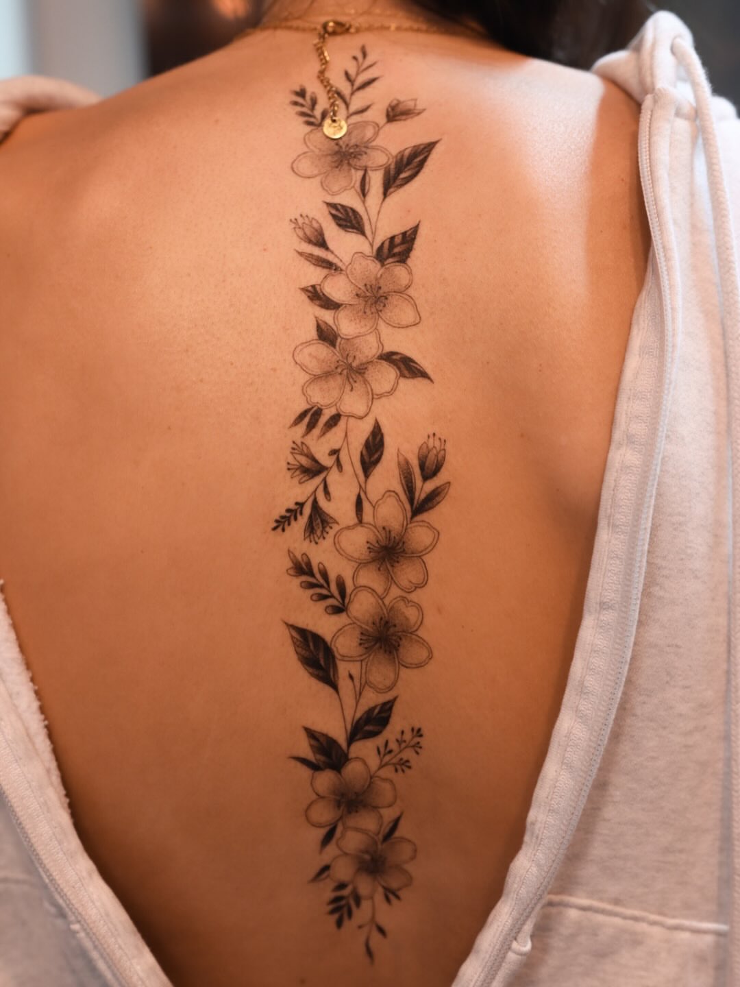 Floral arrangement black and grey tattoo on the back by elvis flores