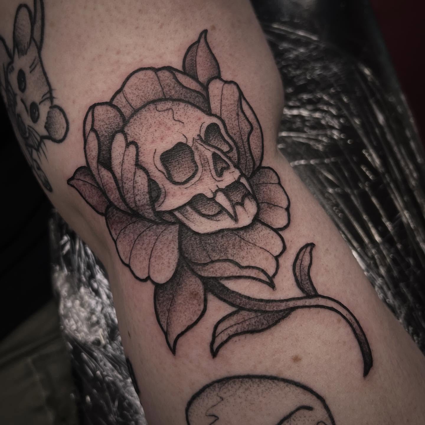 Skull and rose dotwork tattoo on the forearm by Sarah Foltz