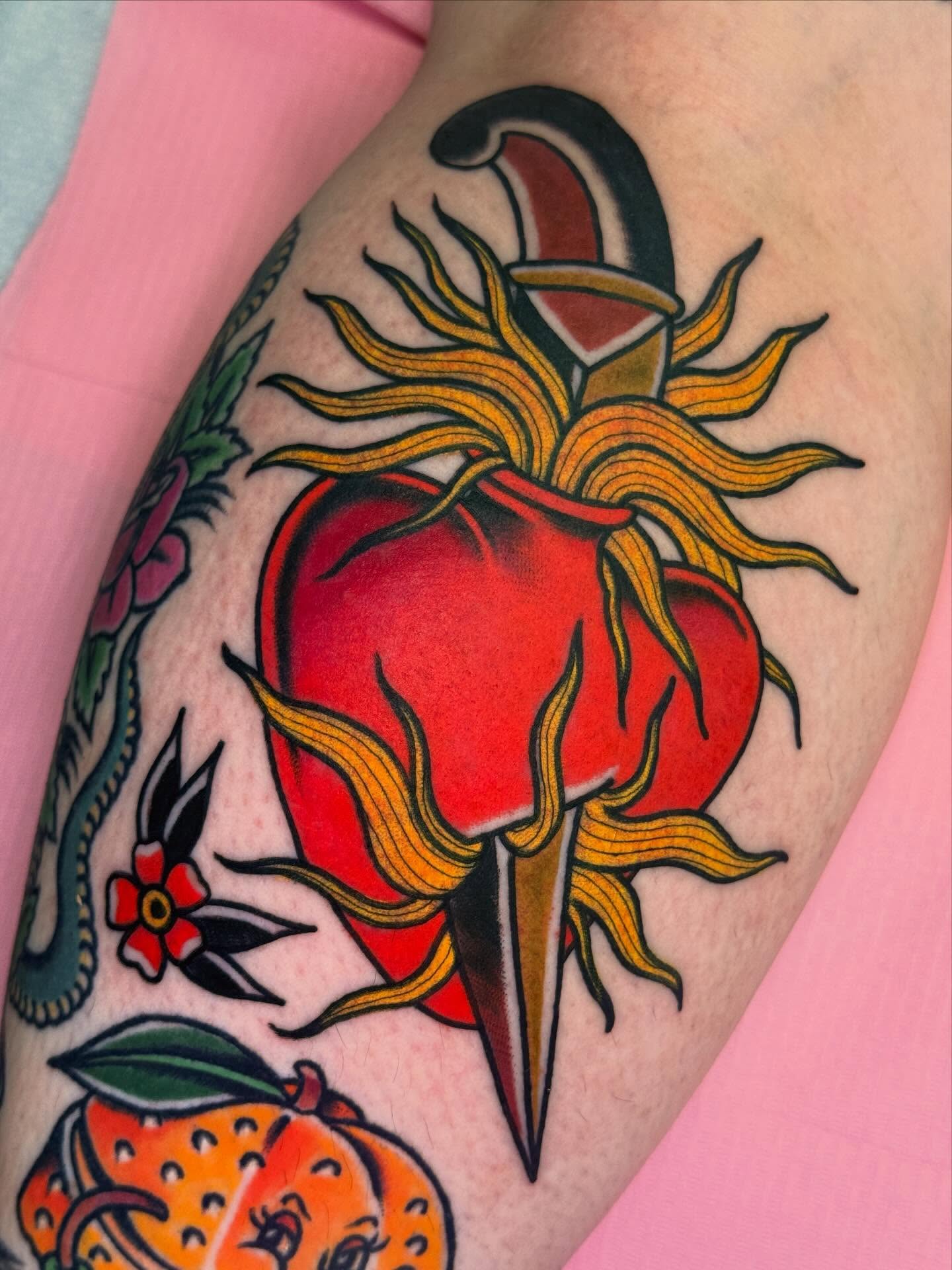Tomato and knife American traditional tattoo on the forearm by Cassie O'Neal DeBord