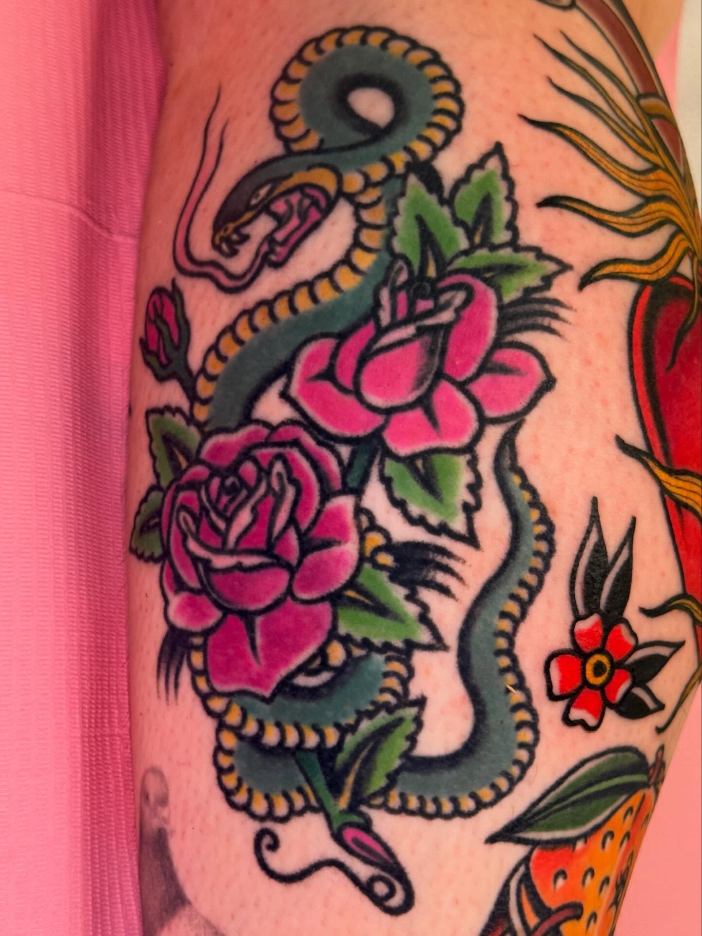 Snake and roses American traditional tattoo on the forearm by Cassie O'Neal DeBord