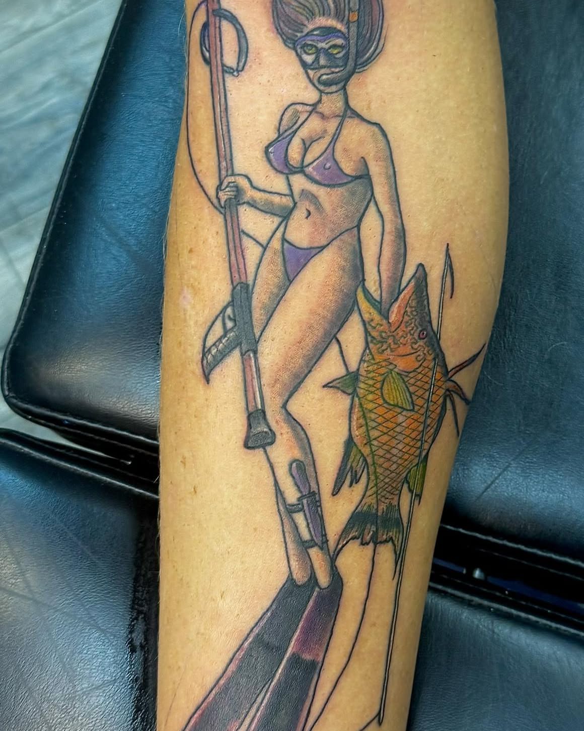 Diver with fish American traditional tattoo on the forearm by Dave Robinowitz