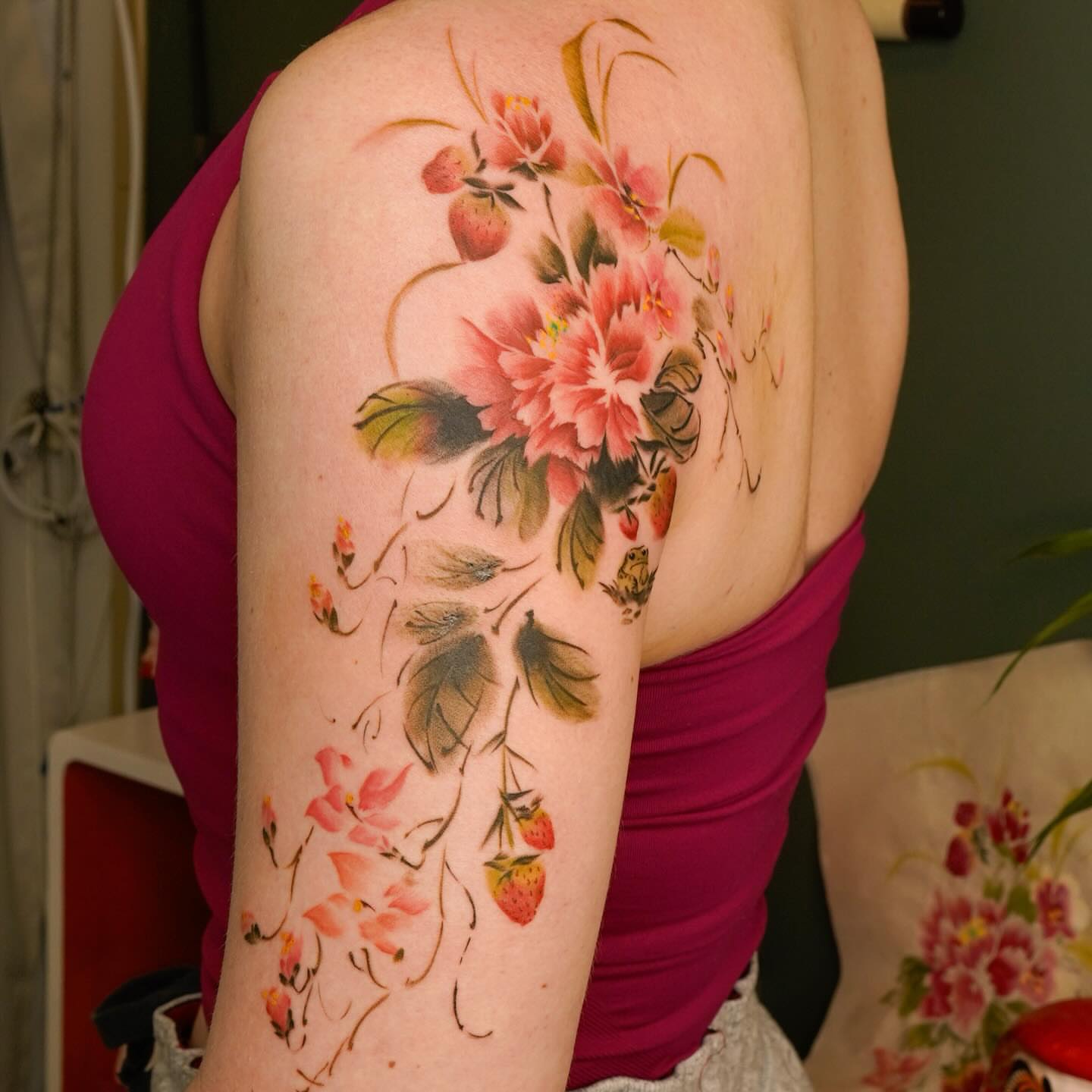 Floral bouquet watercolor tattoo on the shoulder by Nicki Yến