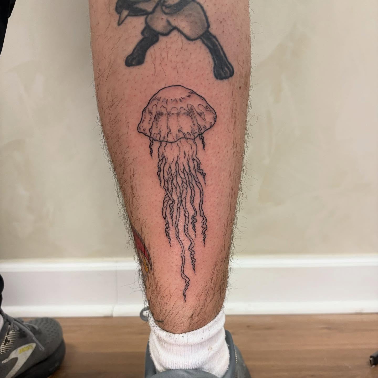 Jellyfish black and grey tattoo on the calf by Dallas Davis