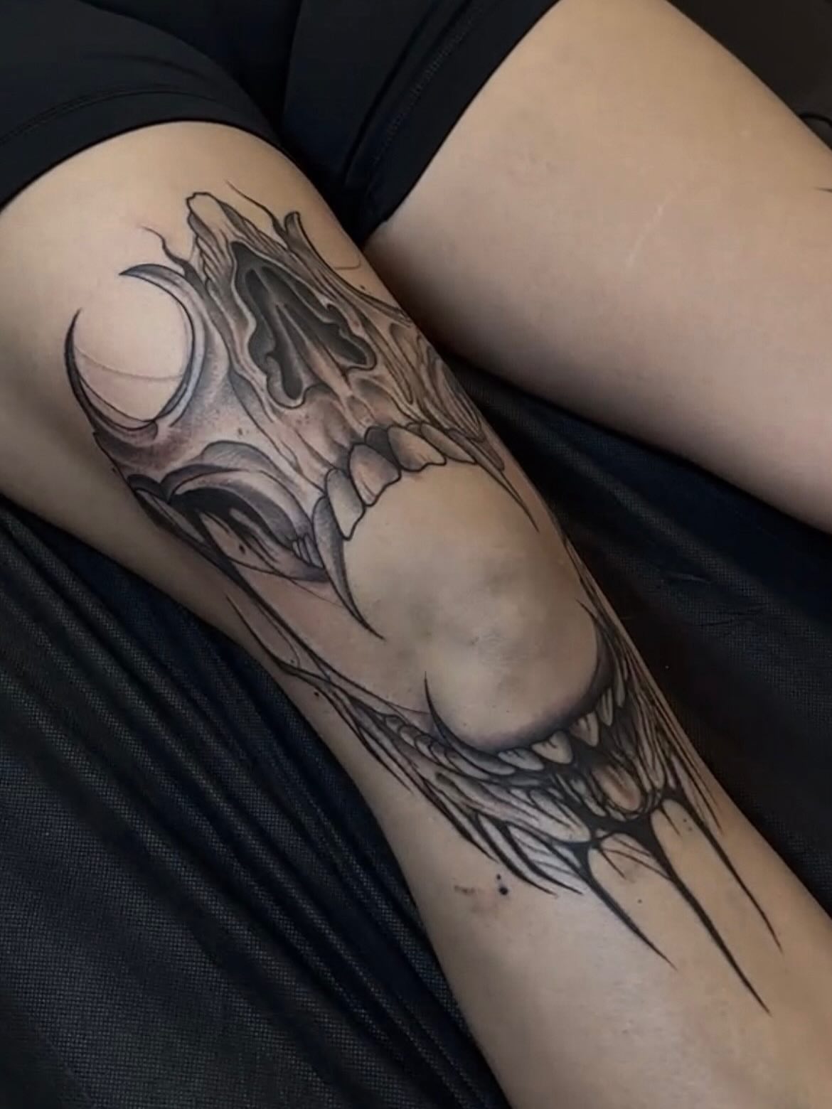 Wolf black and grey tattoo on the thigh by Turk