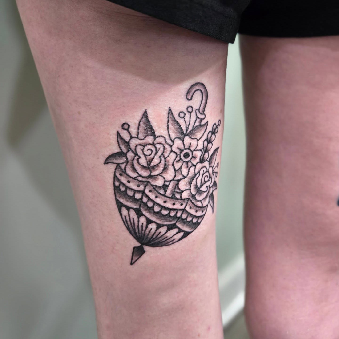 Floral bouquet black and grey tattoo on the thigh by Matt Page