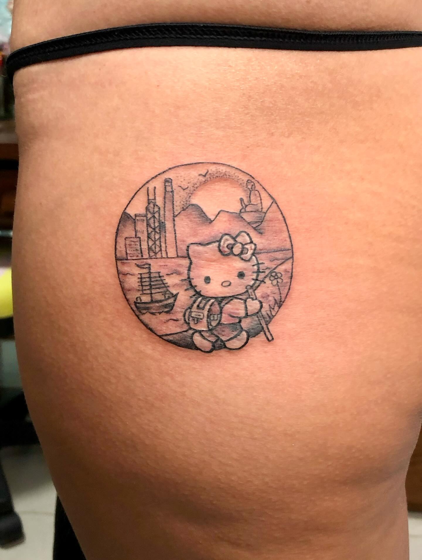 Hello Kitty black and grey tattoo on the thigh by julia seizure - tattooist