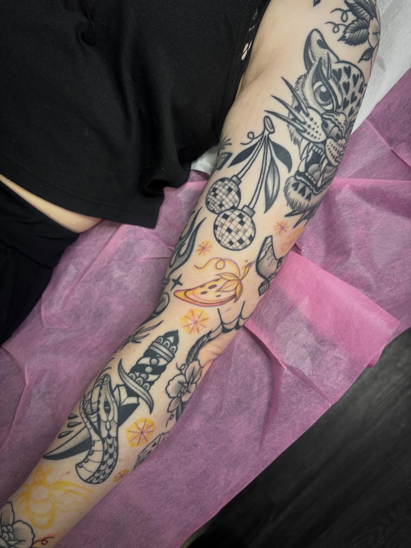 Jaguar and disco ball American traditional tattoo on the forearm by Victoria Bacon