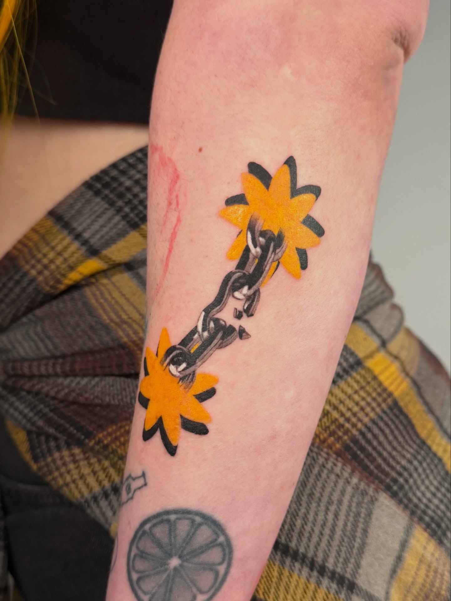 Sunflower and chain American traditional tattoo on the forearm by Jerm Lewis