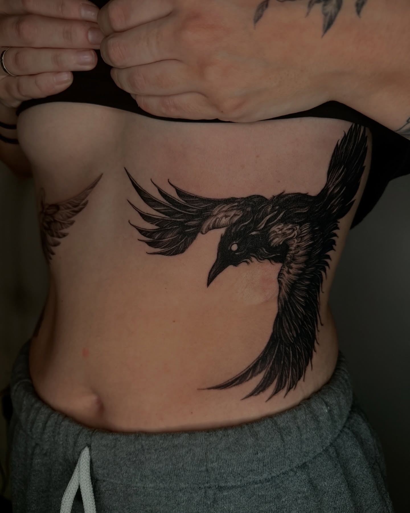 Crow black and grey tattoo on the ribs by Sab