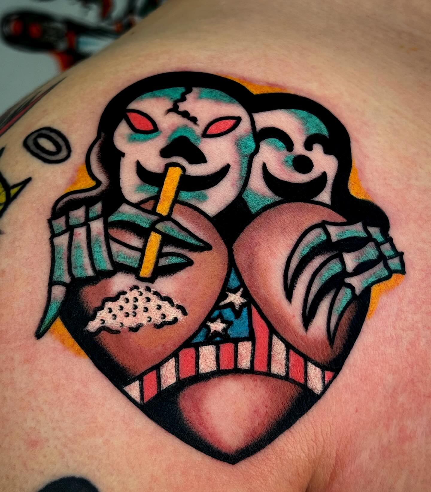 Skulls and heart American traditional tattoo on the shoulder by JAX