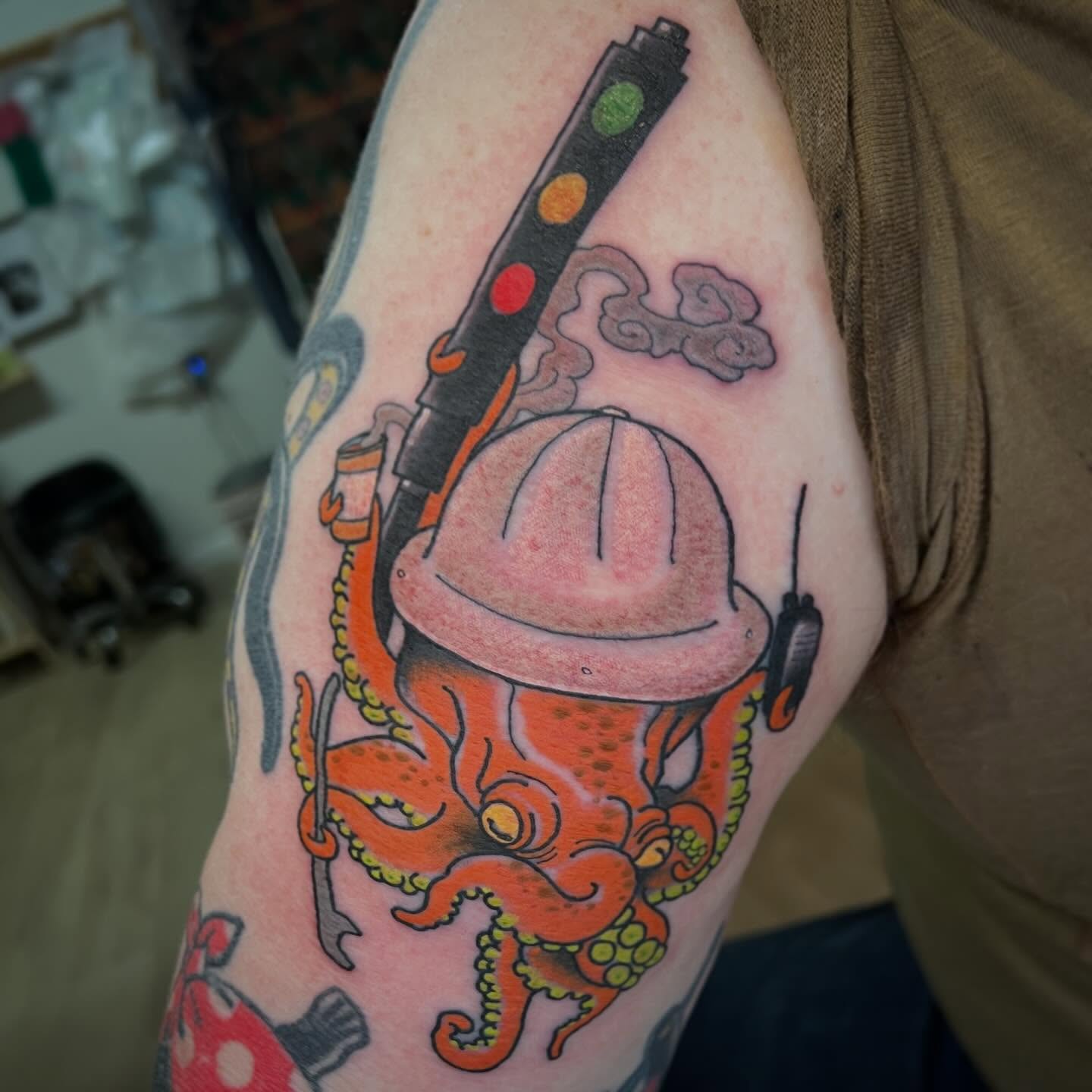 Octopus with hard hat and gun new school tattoo on the forearm by Troy David Souders