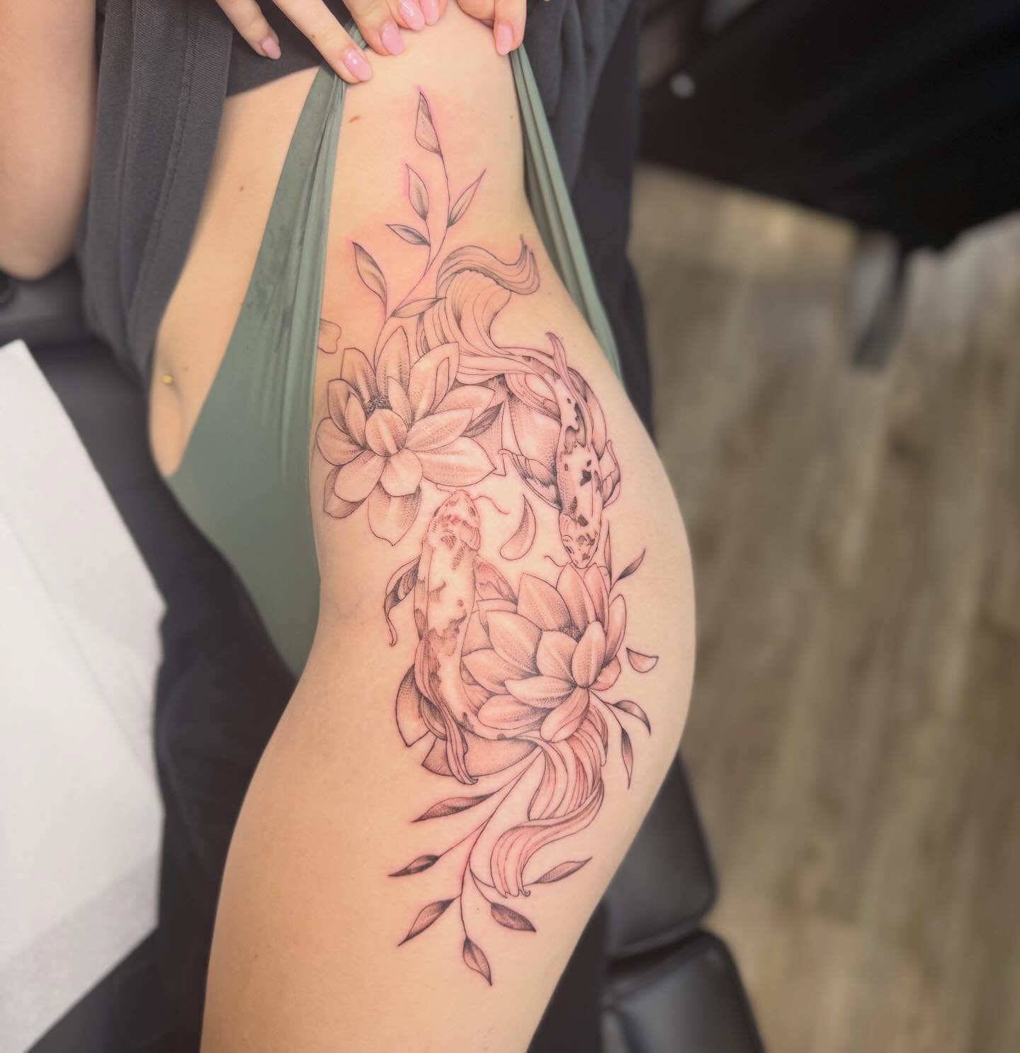 Floral and snake black and grey tattoo on the thigh by Jordan Clifford