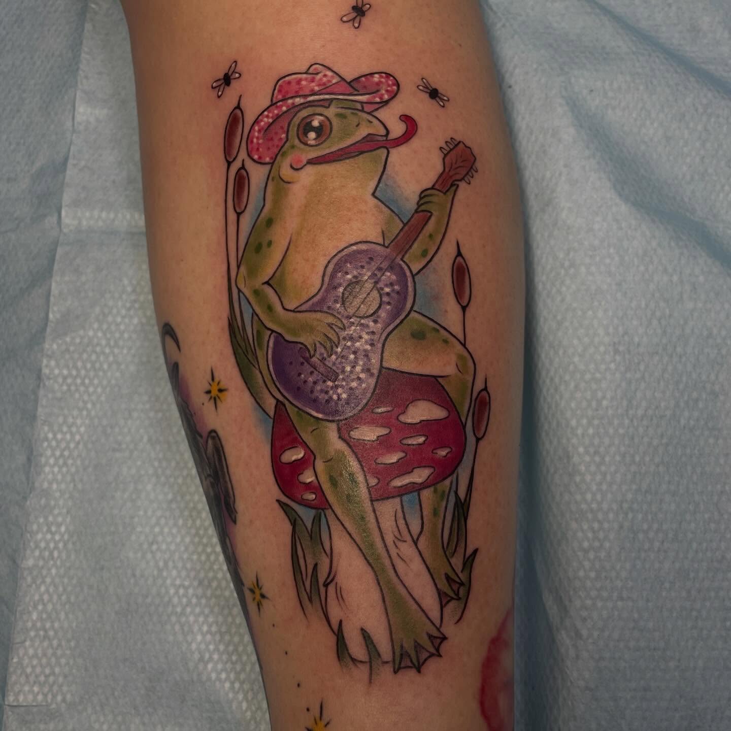 Frog playing guitar American traditional tattoo on the forearm by Stevie Timmreck, Utica, Michigan