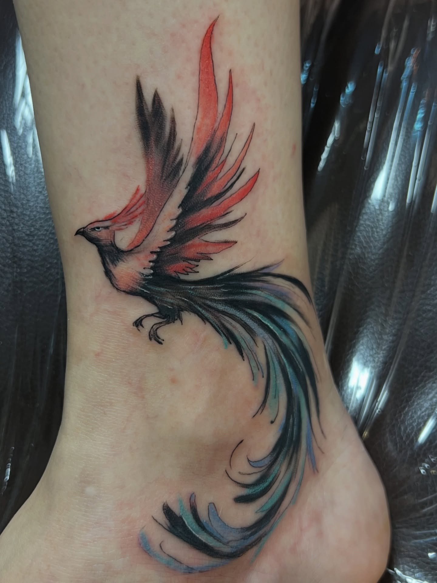 Phoenix watercolor tattoo on the foot by Asap tattoo
