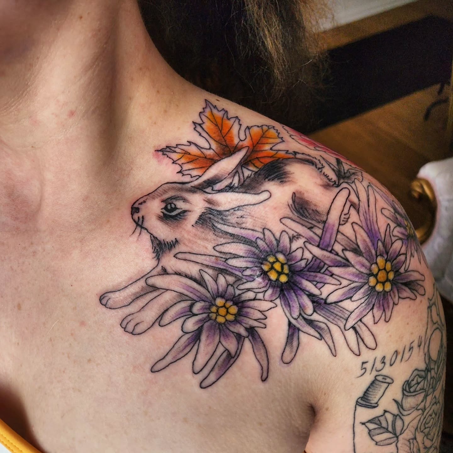 Rabbit and flowers American traditional tattoo on the shoulder by julian