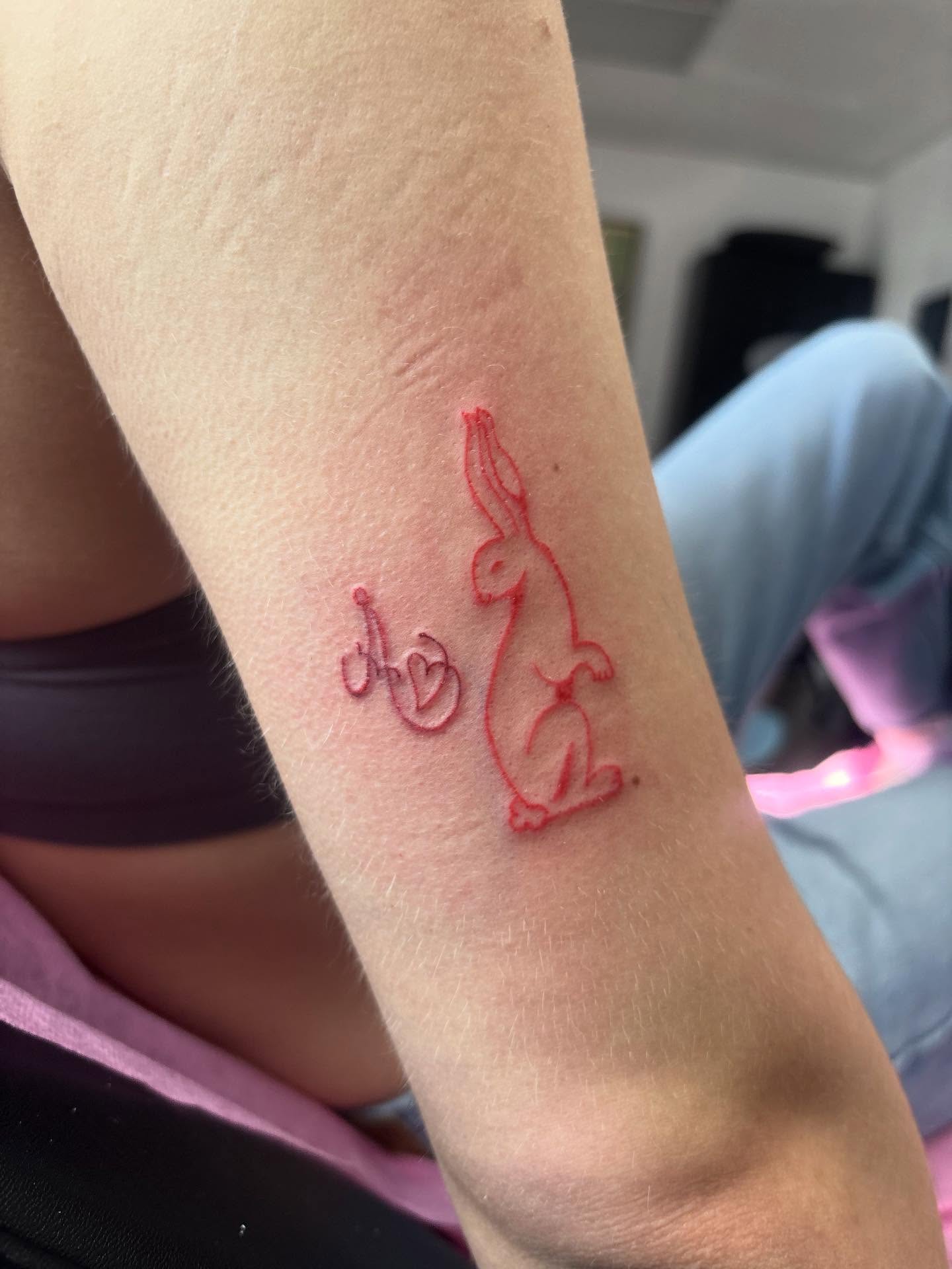 Rabbit and initials fine line tattoo on the forearm by Mickey