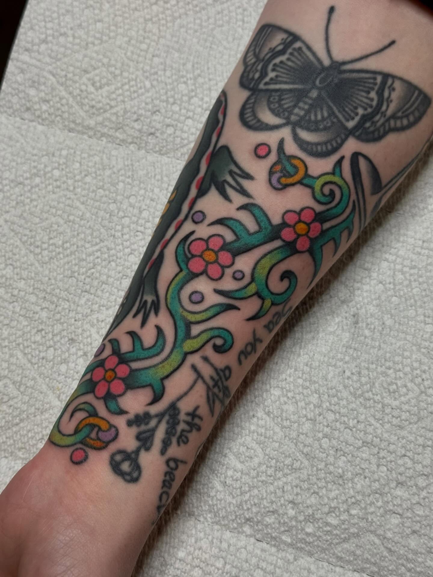 Butterfly and floral vine American traditional tattoo on the forearm by Painted Peach Tattooer