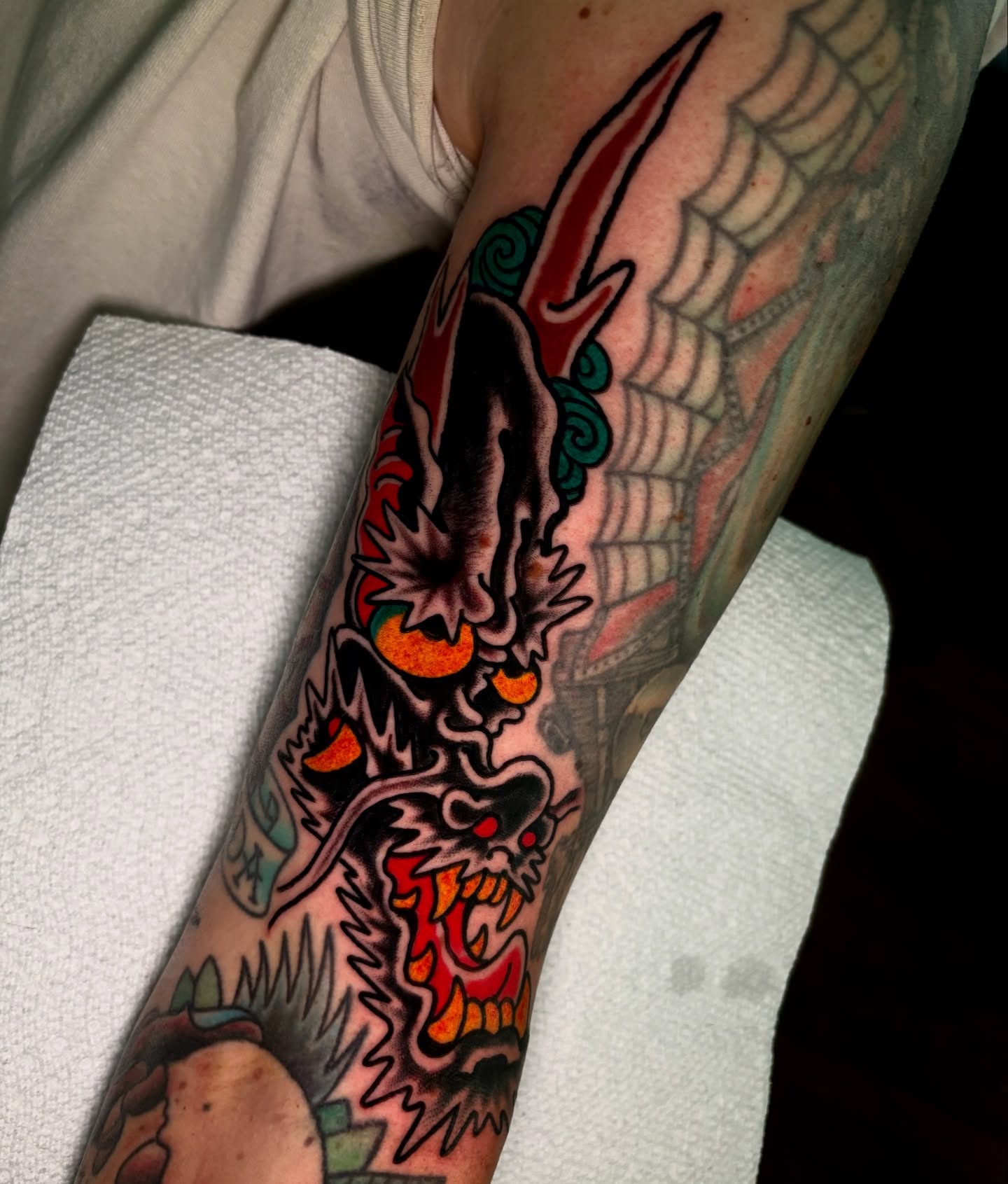 Demon skull American traditional tattoo on the forearm by Santo Zelaya, San Francisco, California