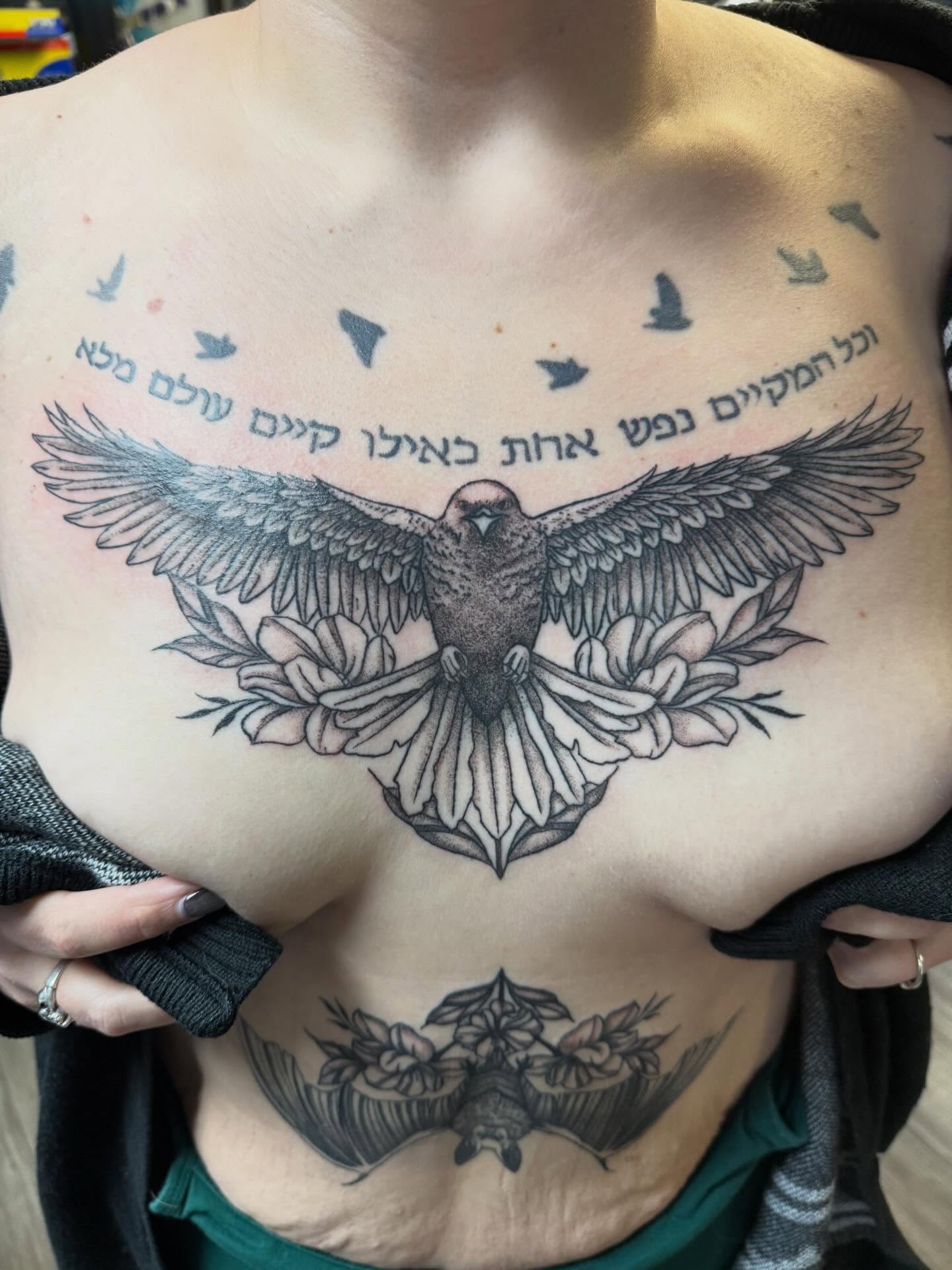 Dove and floral wreath black and grey tattoo on the chest by Elena