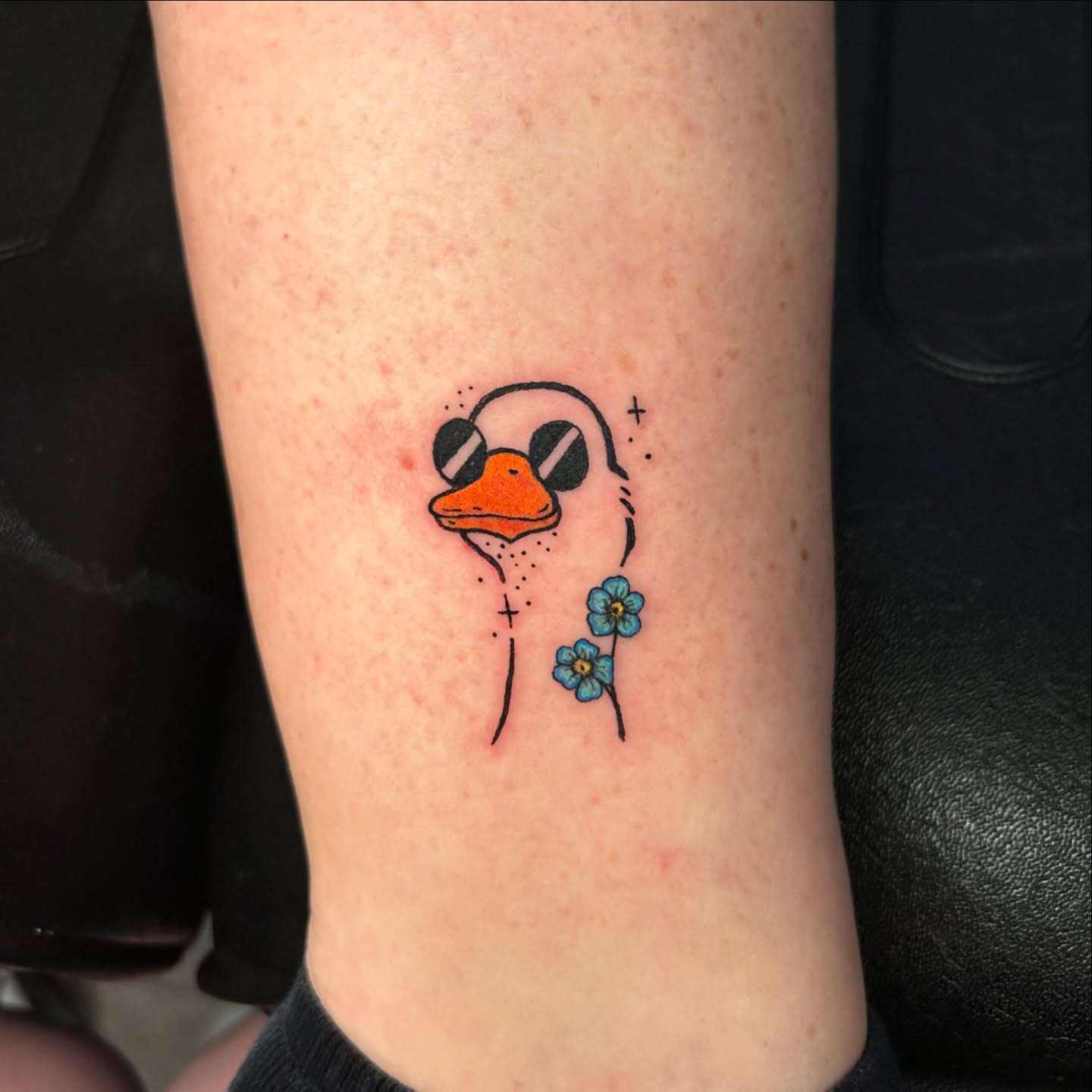 Duck with flowers dotwork tattoo on the forearm by Tess