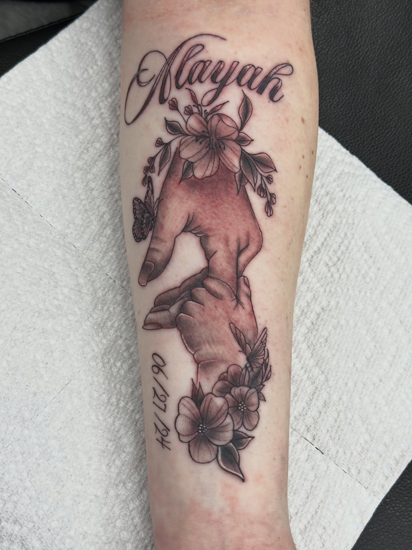 Mother and child black and grey tattoo on the forearm by Sk Pierce