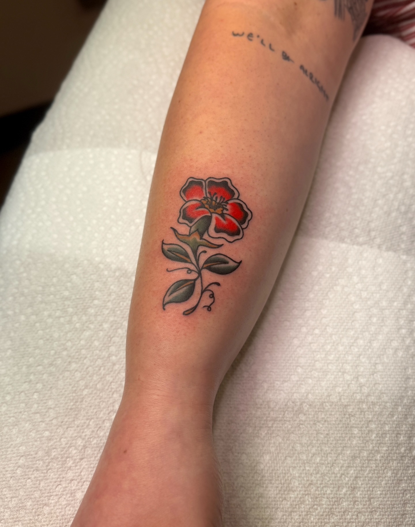 Red rose American traditional tattoo on the forearm by Ethan, Toledo, Ohio