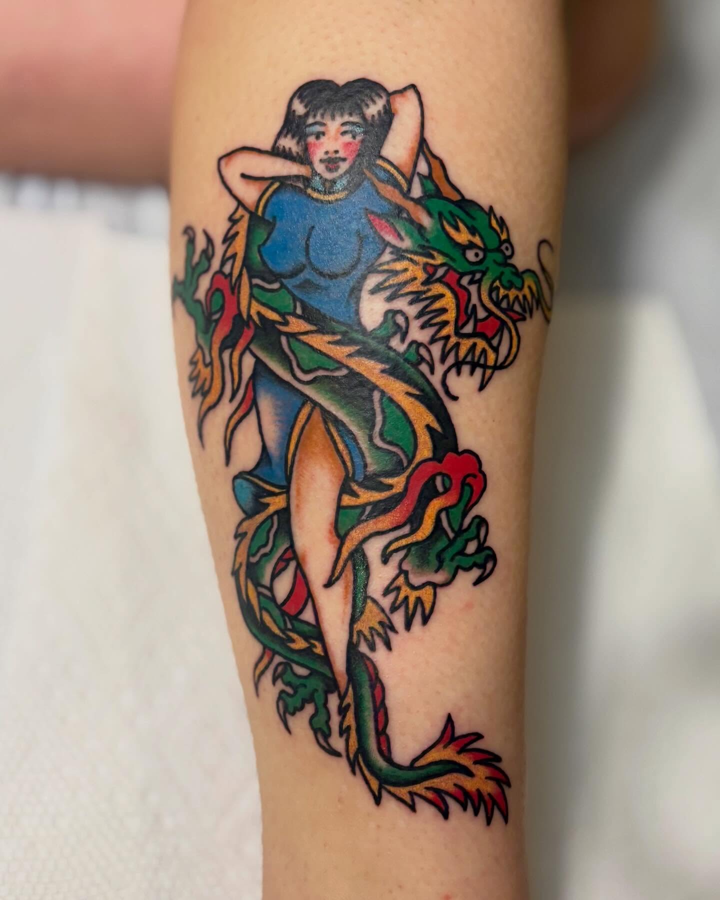 Dragon and woman American traditional tattoo on the forearm by Tia Cave