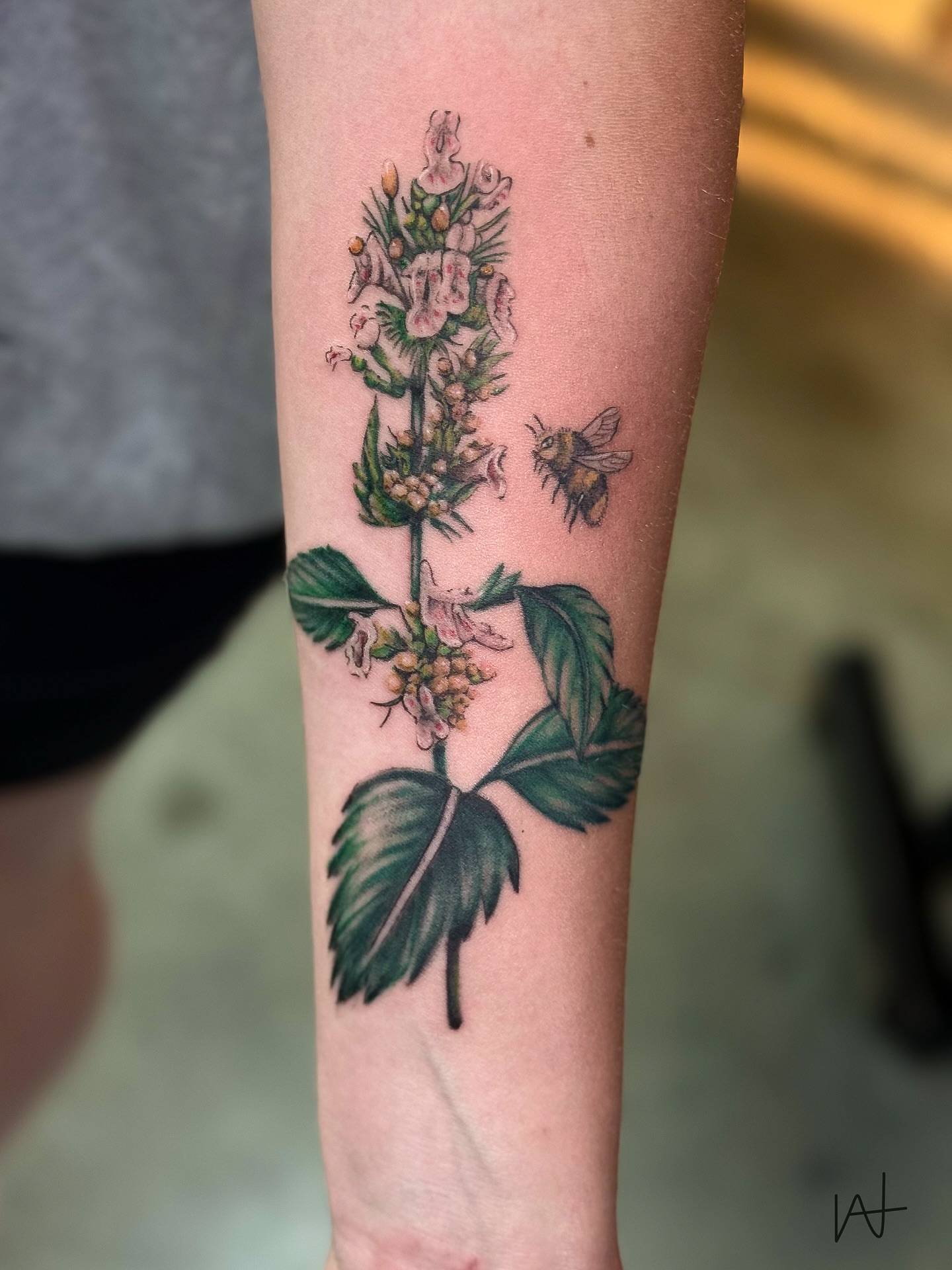 Flower and bee realism tattoo on the forearm by Kat Parmu