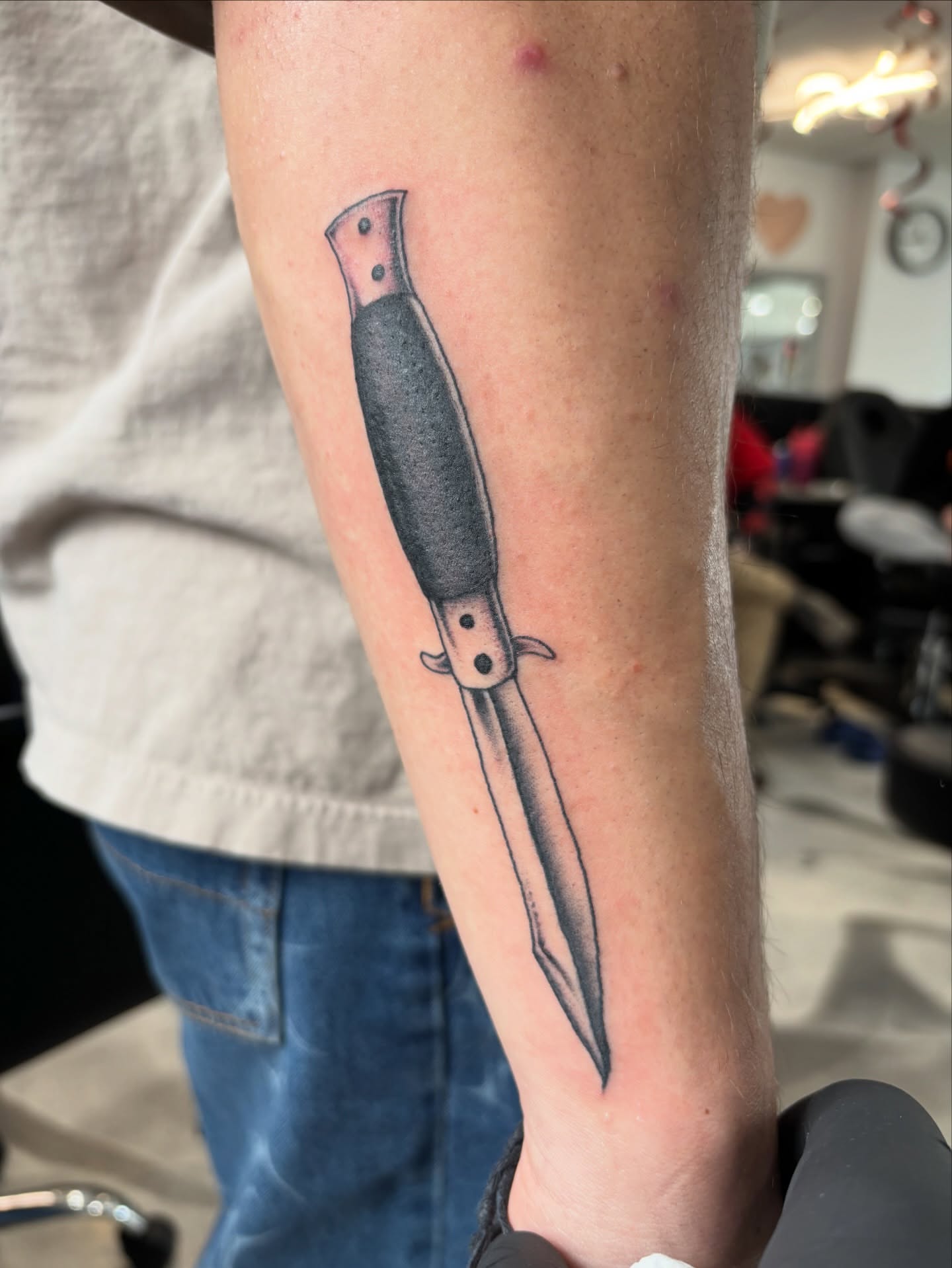 Knife black and grey tattoo on the forearm by Miklo Montoya